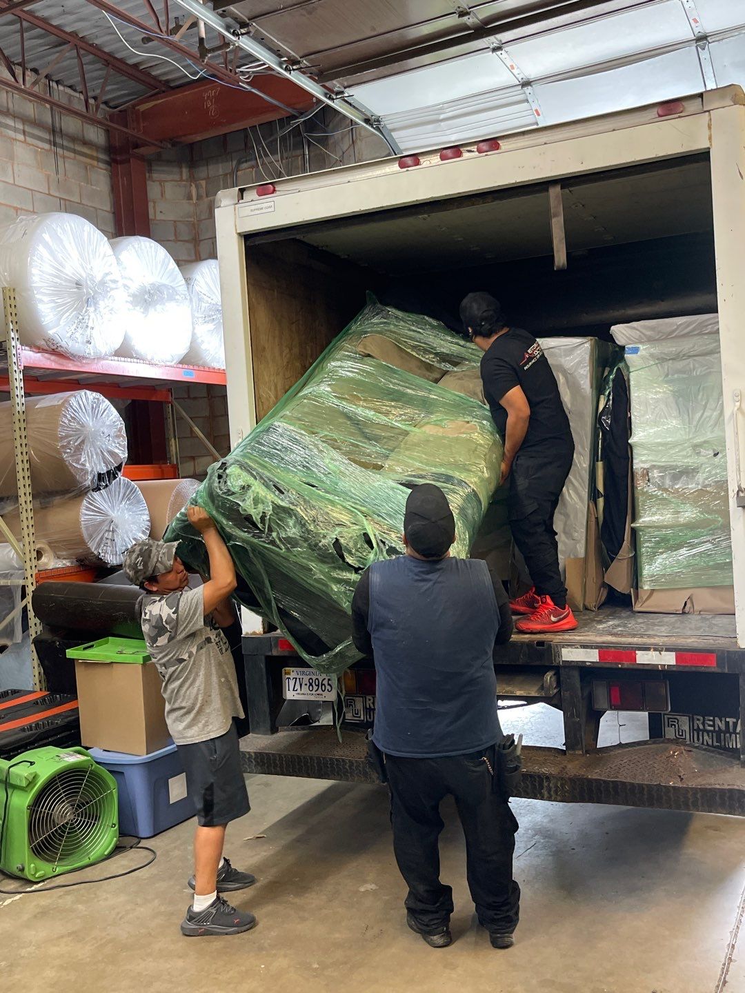 Water damage restoration underway in Ashburn: structural drying equipment positioned in affected interior space.