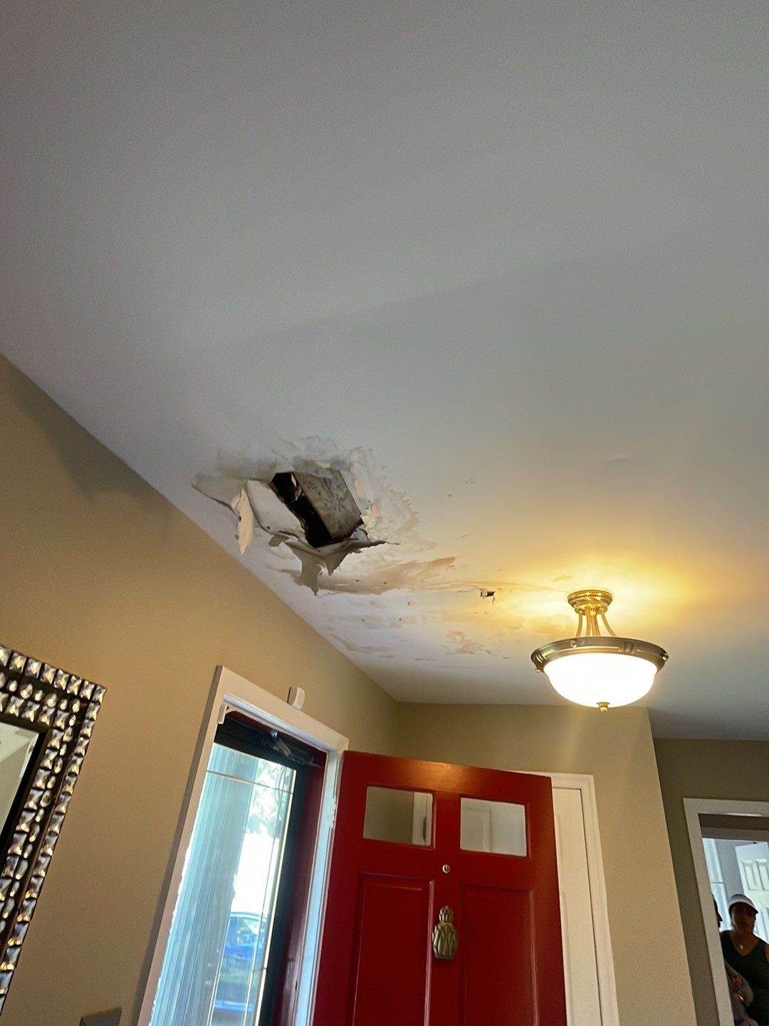 Structural drying equipment positioned beneath compromised ceiling during active water damage mitigation.