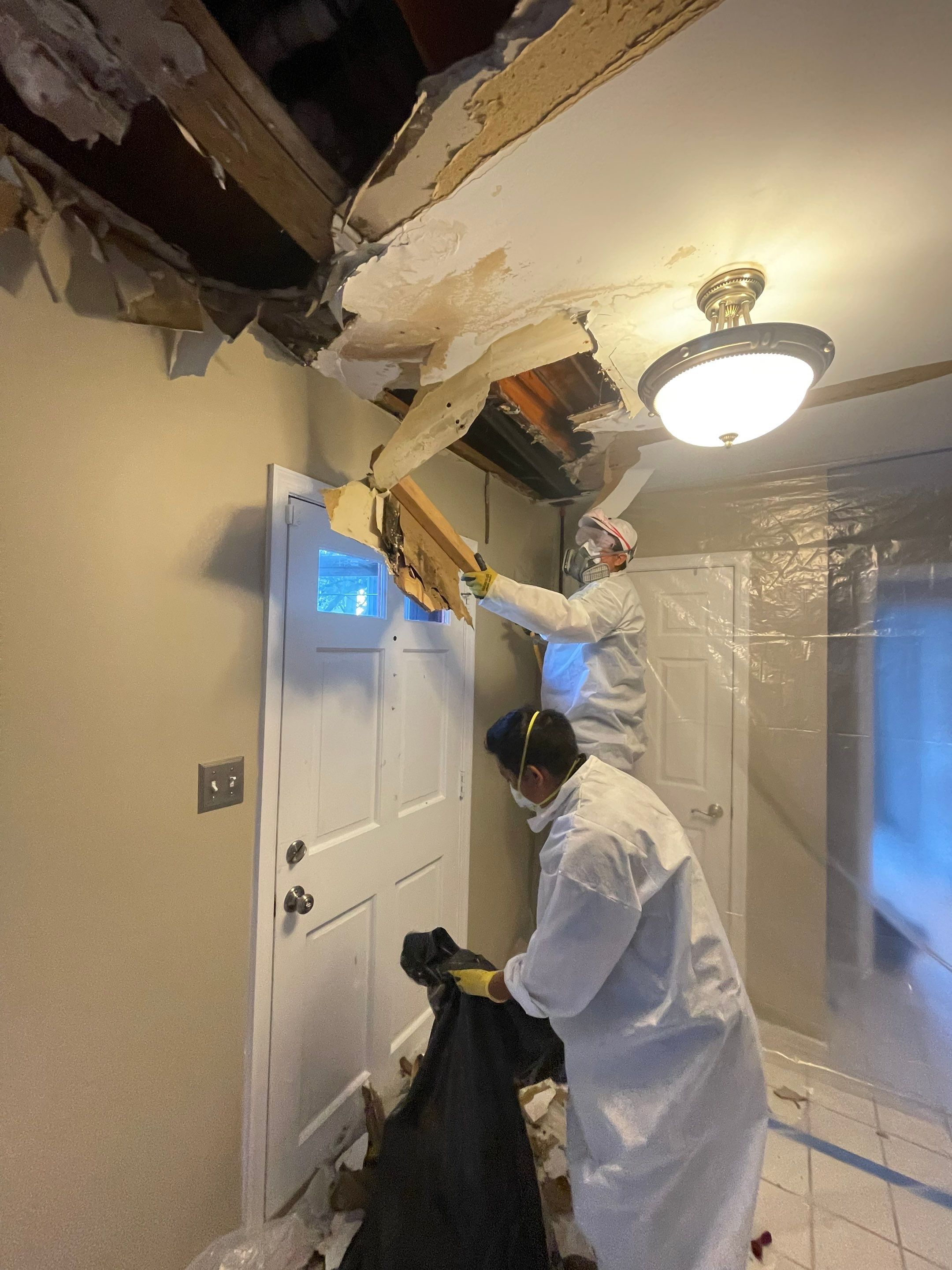 Containment barrier erected around water-damaged ceiling section during Vienna water restoration.