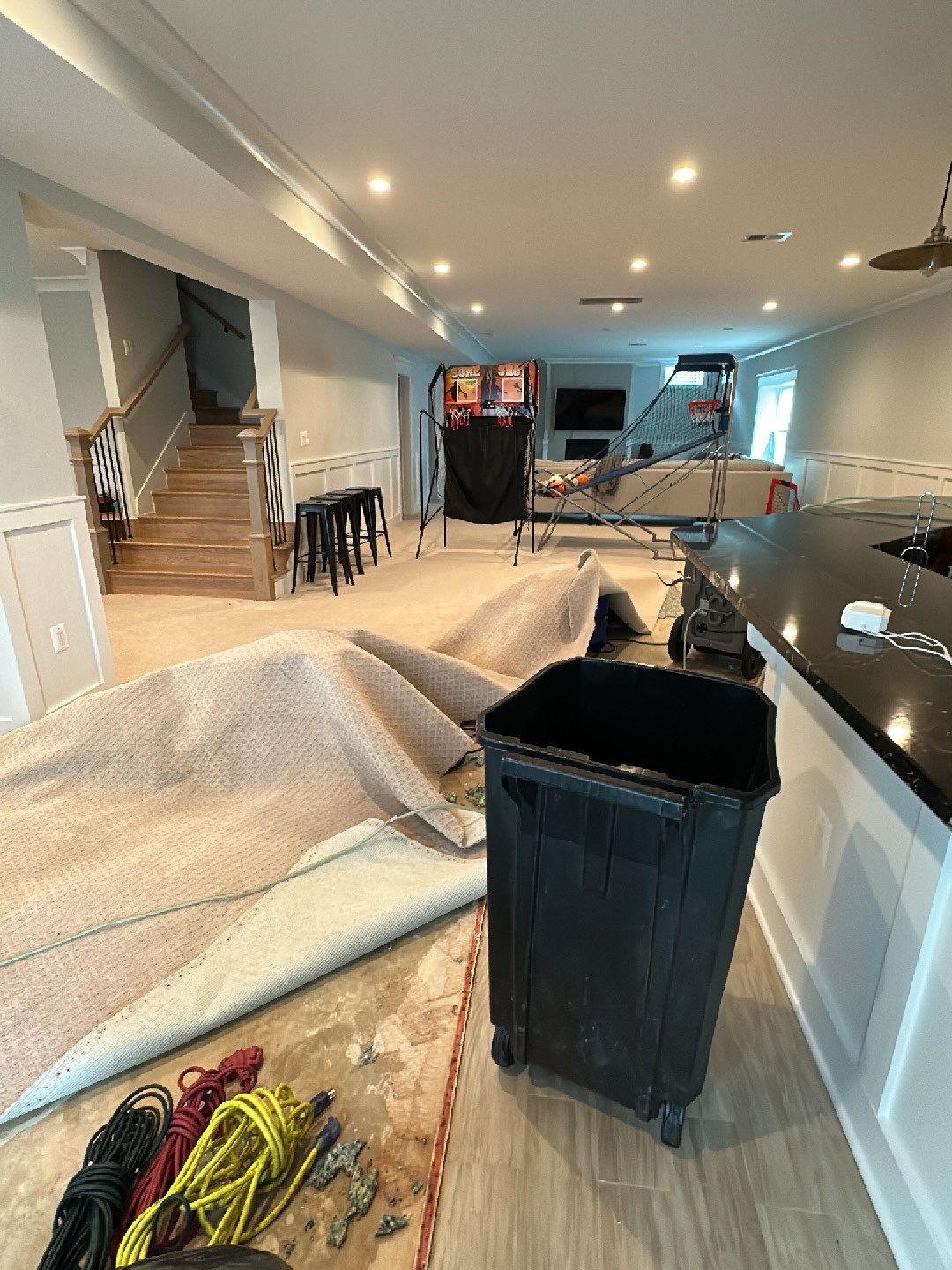 Water-damaged carpet and subfloor in McLean home with dehumidification equipment positioned for structural drying.