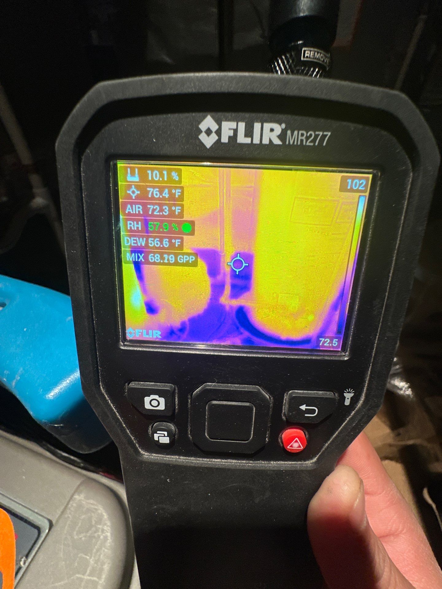 Continued drying progress during water restoration work, monitoring moisture levels in structural materials.