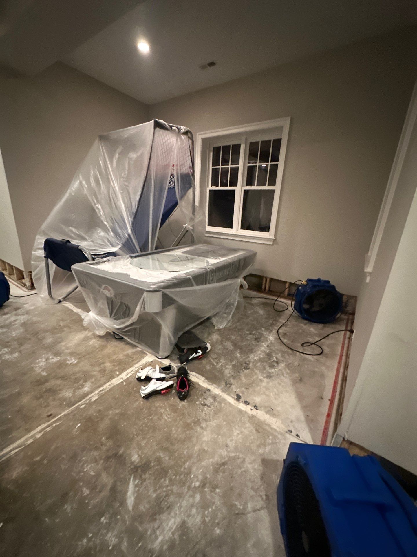 Initial water damage assessment in Falls Church showing structural drying setup with equipment placement.
