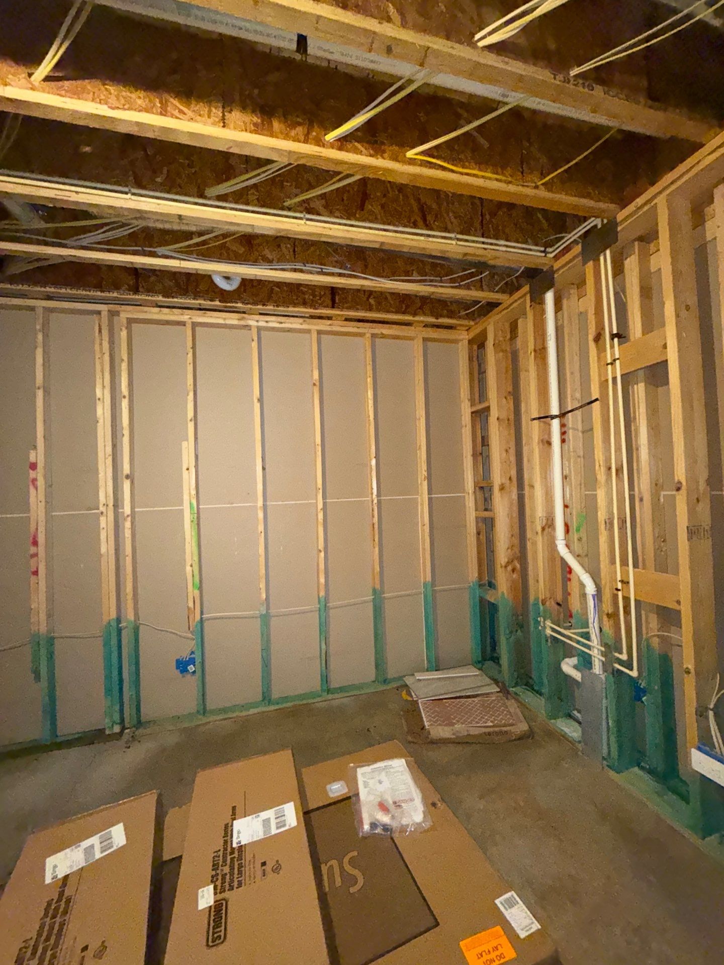 Mid-stage water damage work in Ashburn with drywall sections removed to expose framing and allow interior cavity drying.