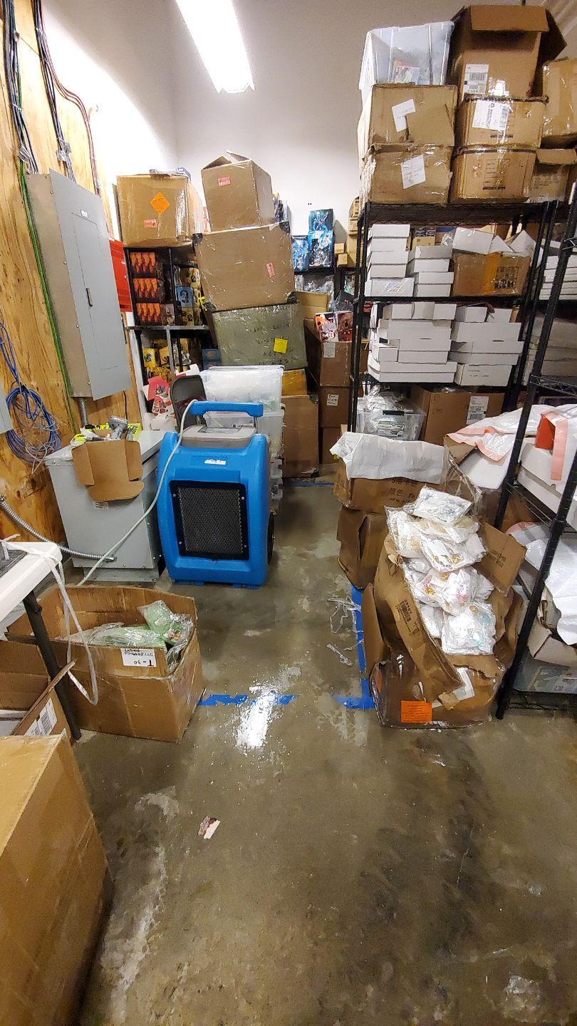 Dehumidification equipment positioned during mid-stage drying of water-damaged interior space.
