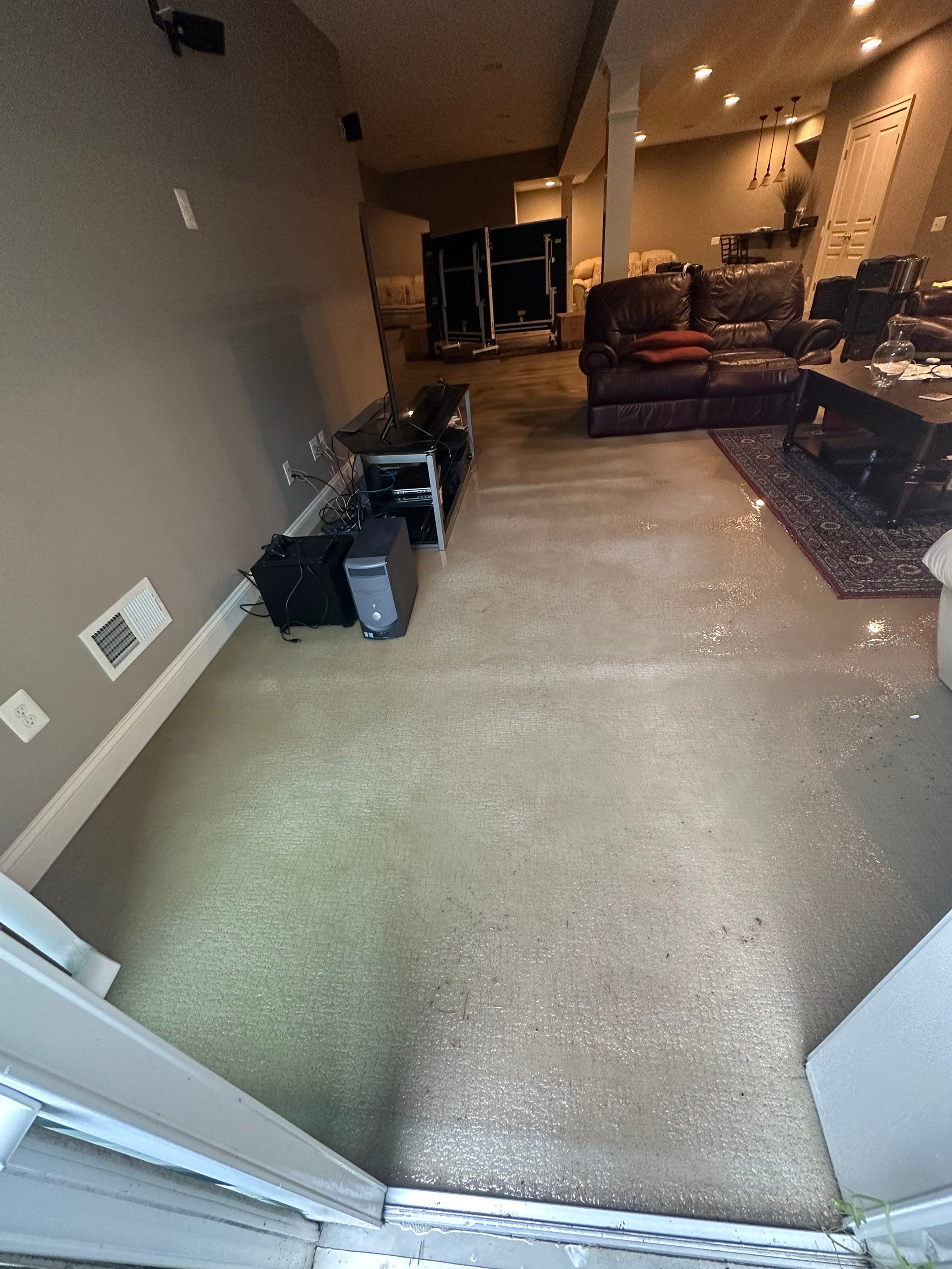 Standing water extraction underway in Centreville water damage restoration, initial assessment phase.