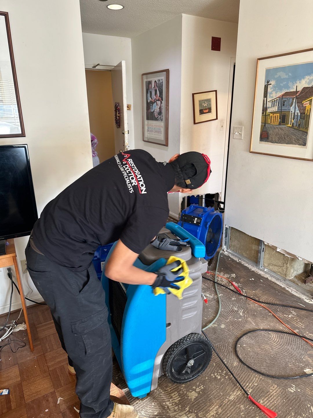 Moisture monitoring and equipment adjustment during mid-stage water restoration drying cycle.