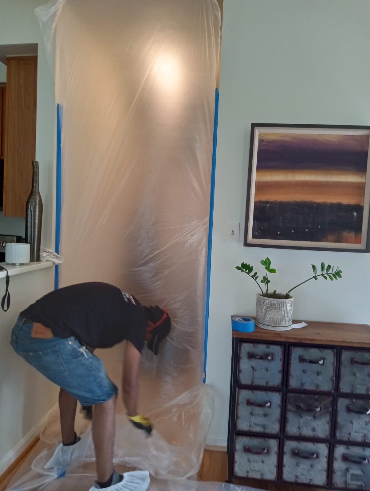 Water-damaged ceiling with visible staining and structural compromise in Alexandria home, dehumidification equipment positioned for drying.
