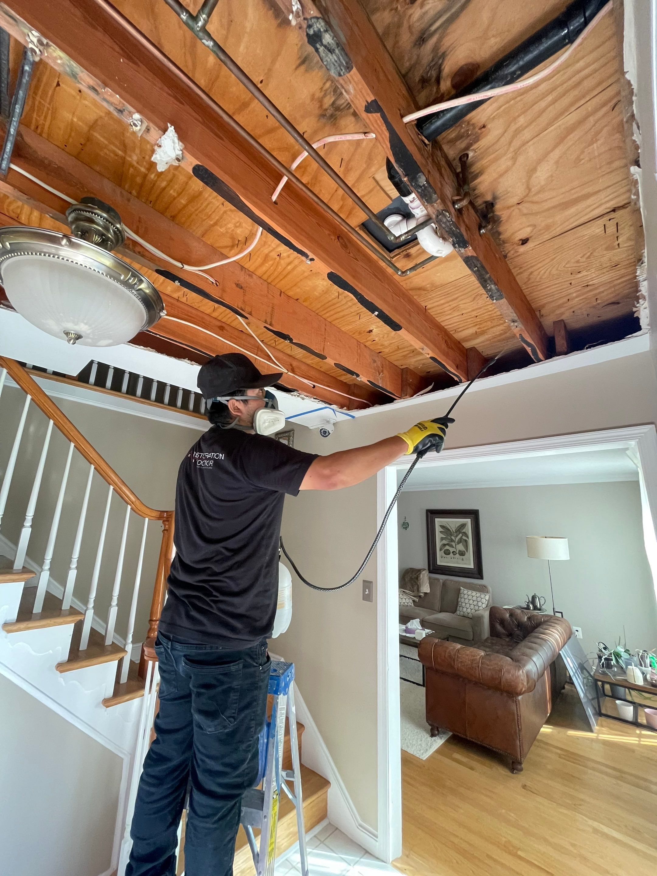 Standing water extraction underway in Vienna water damage restoration, with wet carpet and flooring visible.