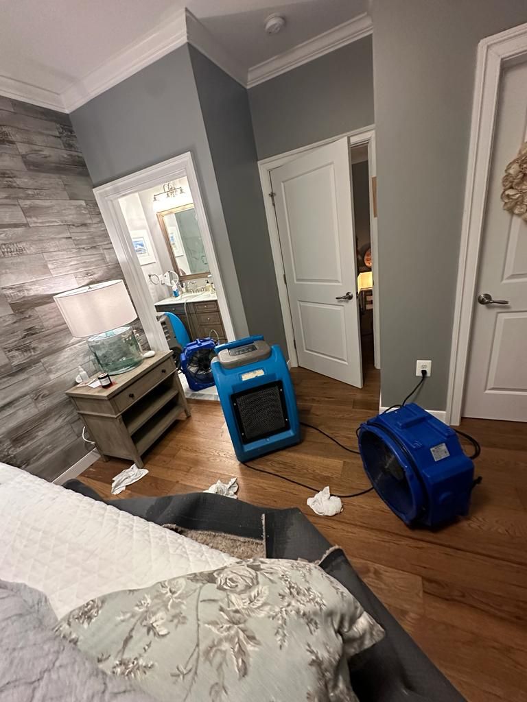 Mid-stage drying showing continued dehumidifier operation and moisture extraction from damaged ceiling area.