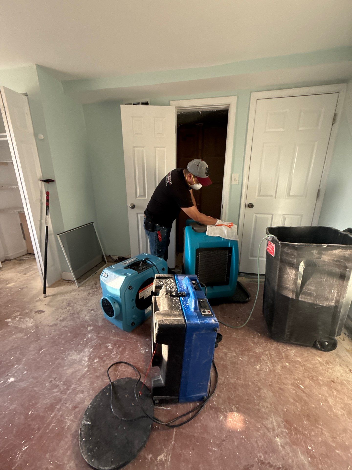 Ceiling material removal and structural inspection during water damage restoration.