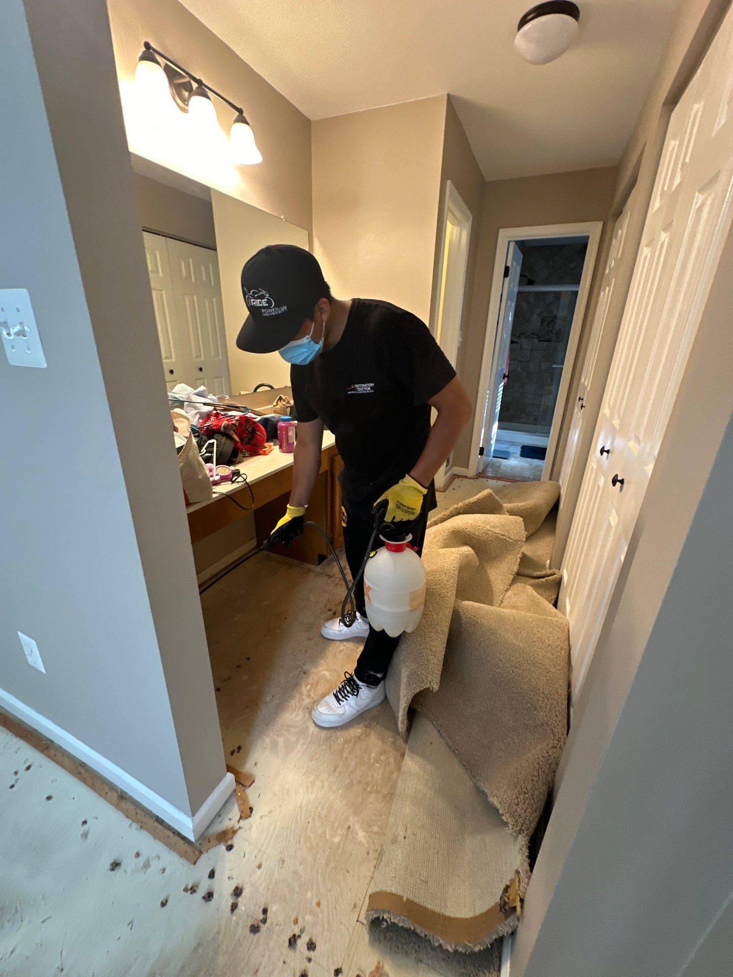 Mid-stage drying setup showing dehumidifiers and air movers extracting moisture from affected flooring areas.