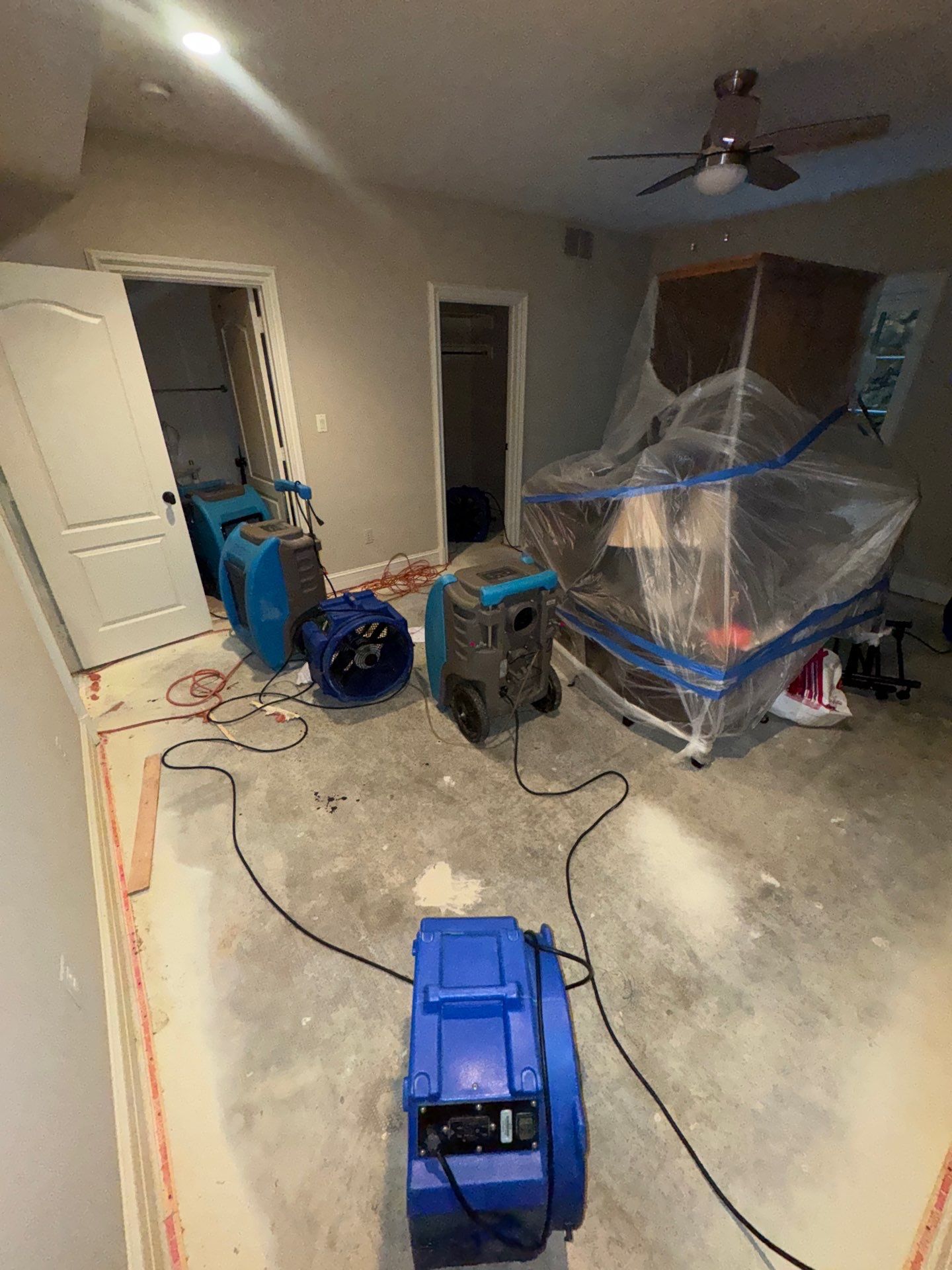 Structural drying equipment positioned within containment to manage moisture and prevent mold spread.