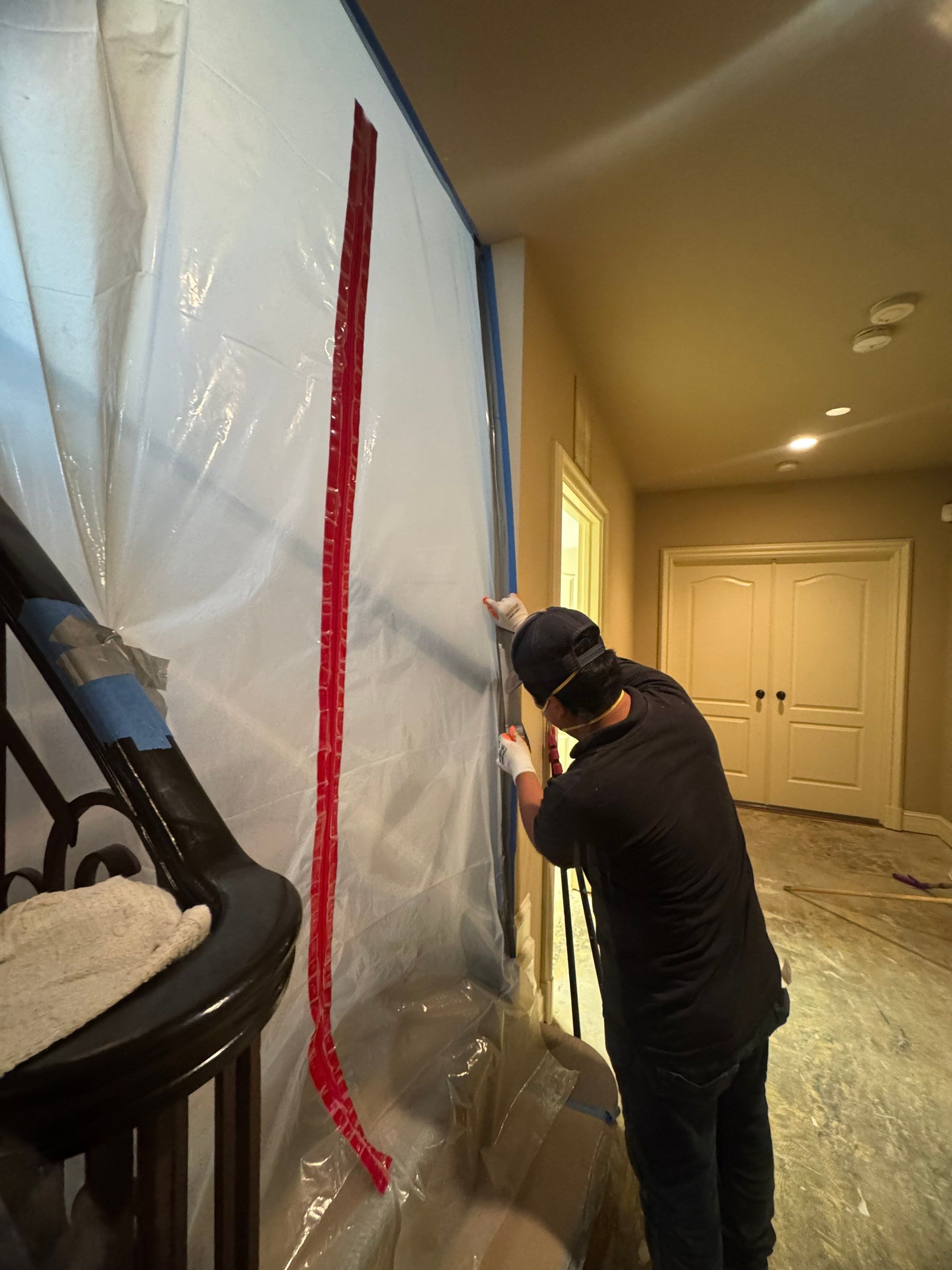 Carpet and subflooring extraction continuing within sealed containment zone.