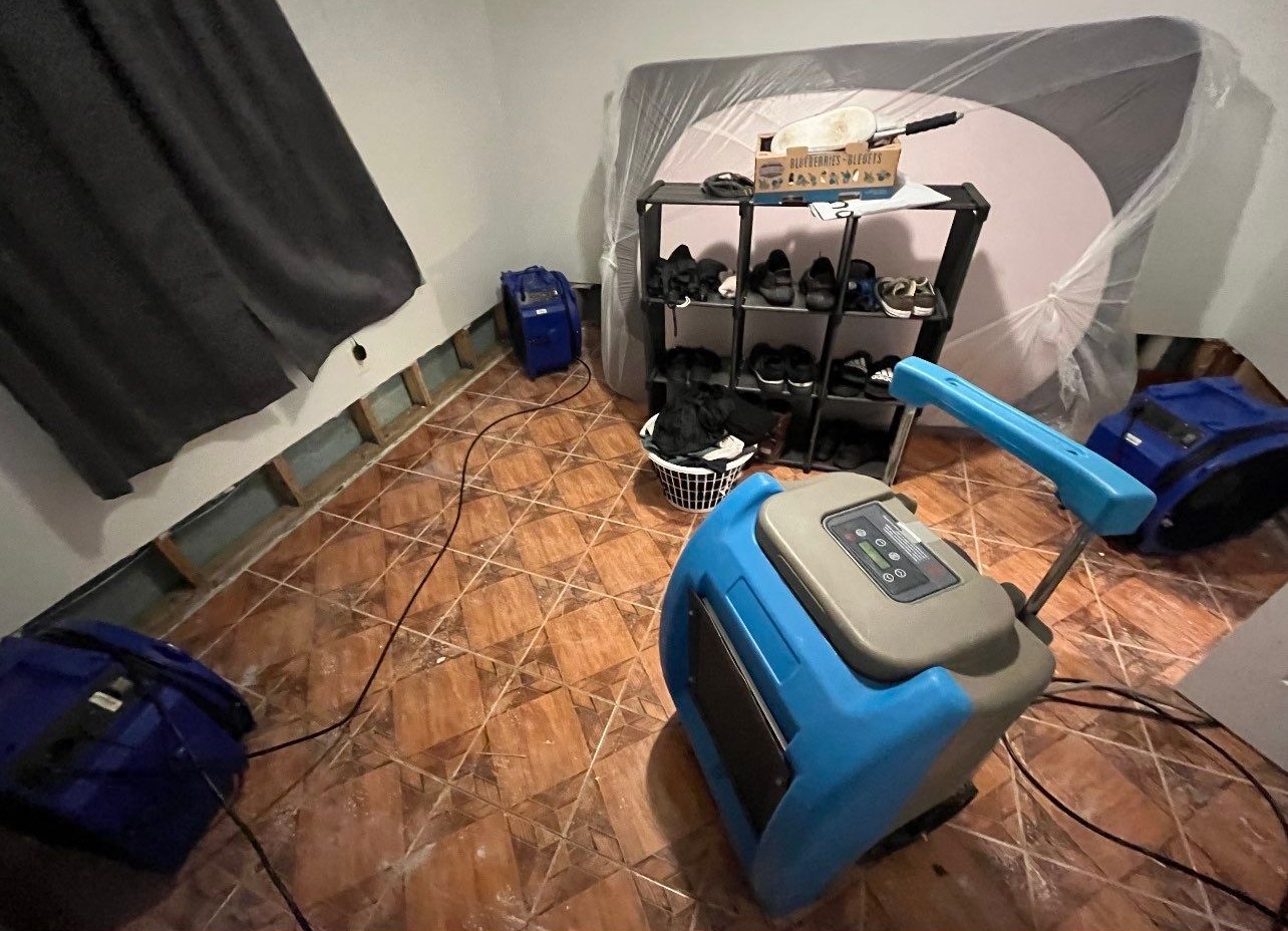 Moisture monitoring equipment tracking drying progress in affected areas.