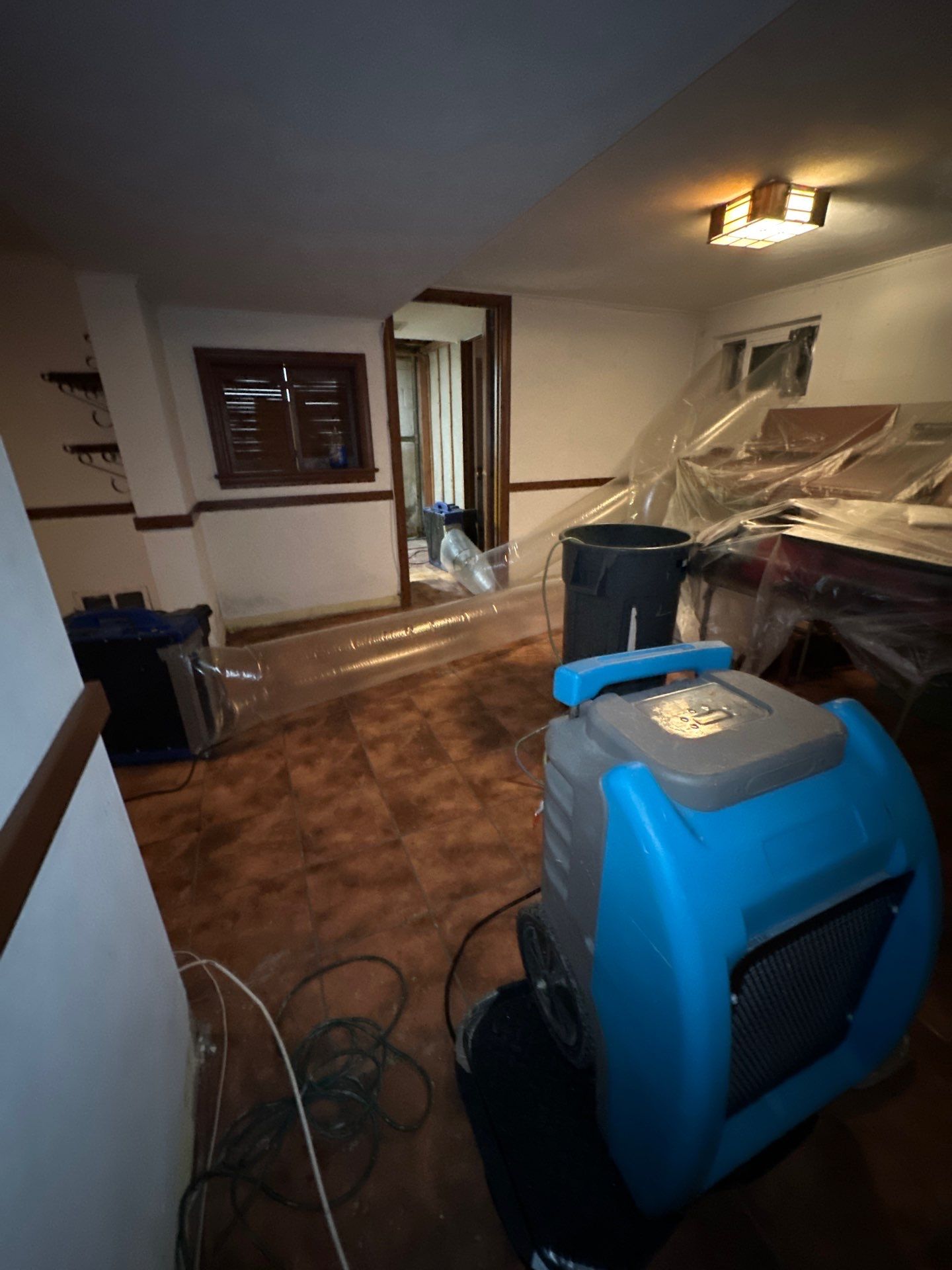 Structural drying in progress with moisture-control equipment positioned throughout the affected space.