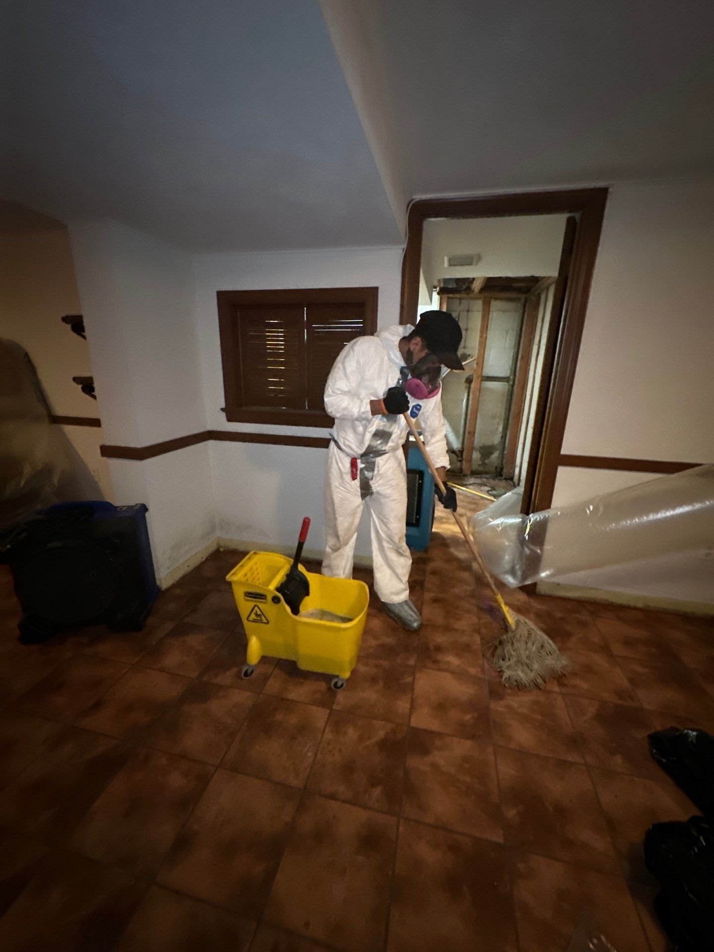 Mid-stage drying phase showing dehumidifiers and air movers managing moisture removal.