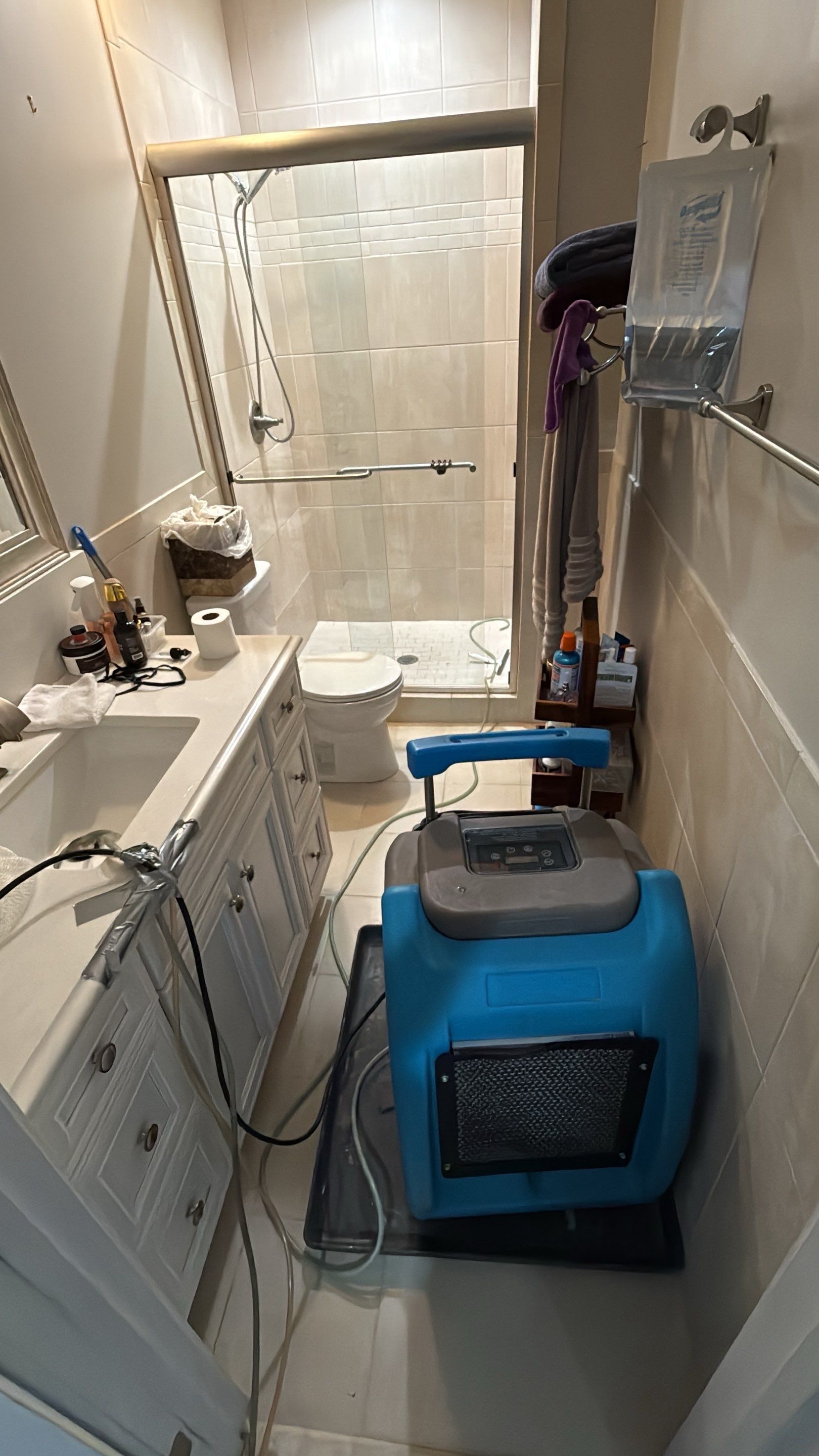 Mid-stage drying setup showing multiple dehumidifiers and air circulation units managing moisture removal from structure.