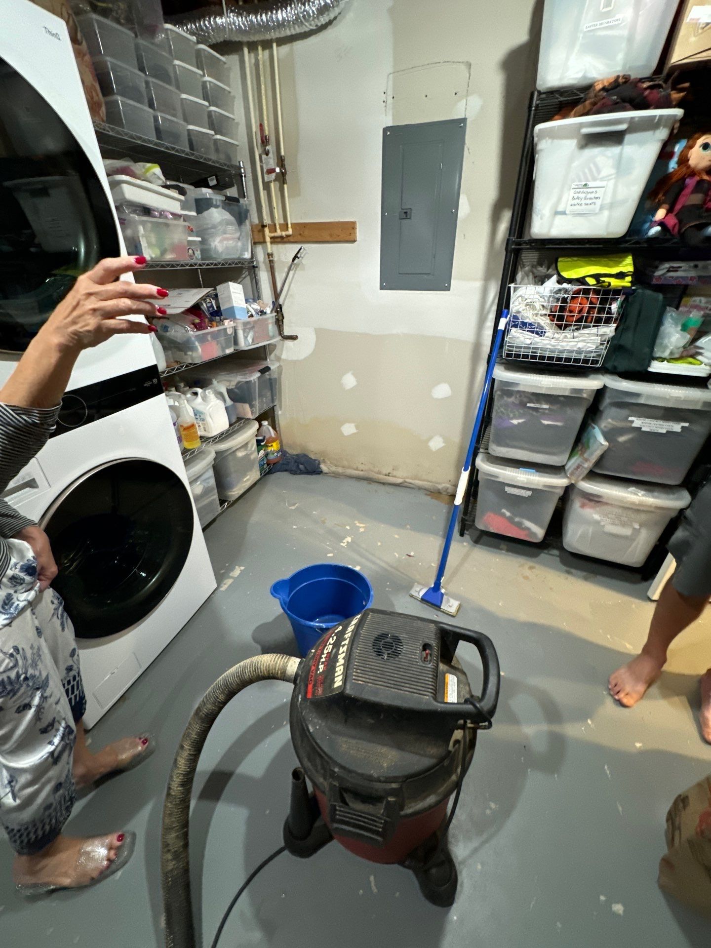 Standing water extraction underway in Falls Church water damage restoration, moisture mapping in progress.