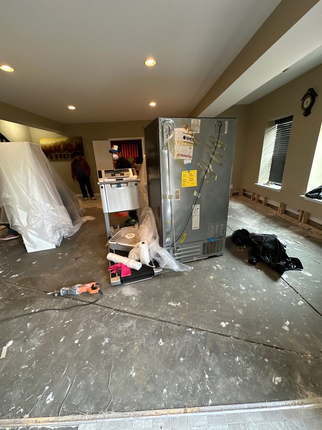 Mid-stage drying setup showing dehumidifier and air movers working to extract moisture from affected areas.