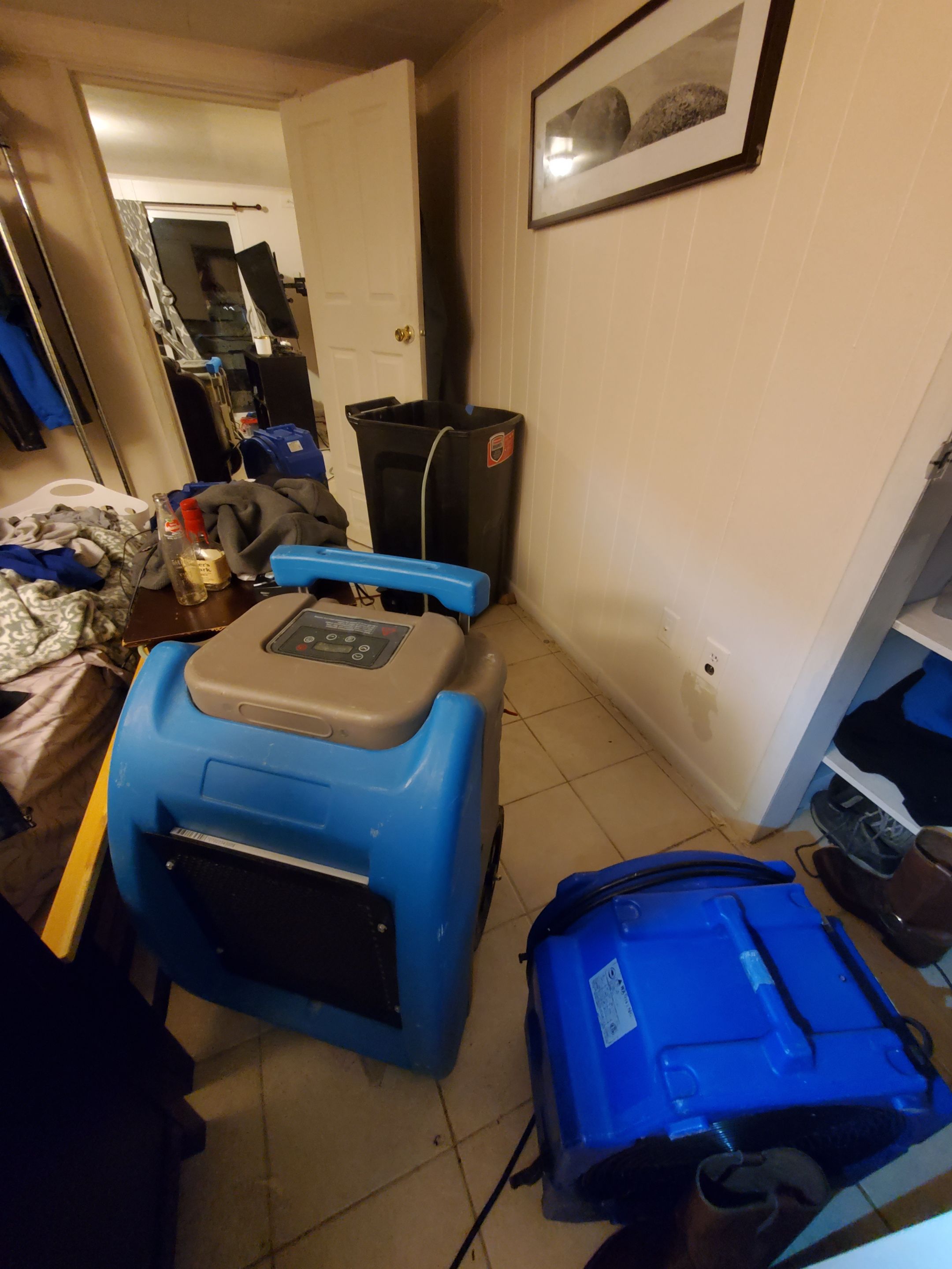 Final-stage drying verification, equipment staged for removal after water damage restoration.