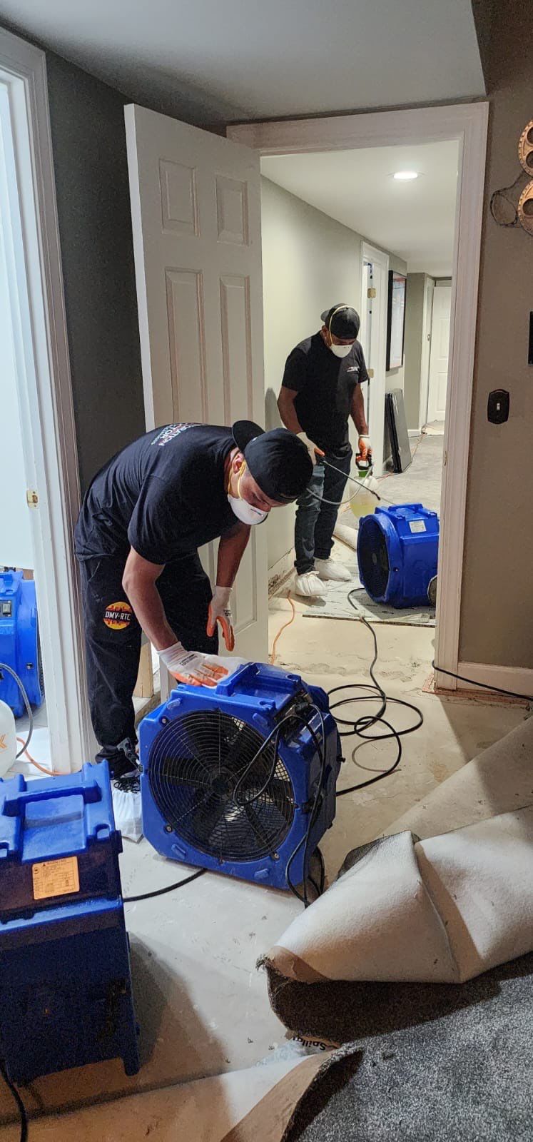 Standing water extraction underway in Manassas water damage restoration, removing pooled water from affected flooring.
