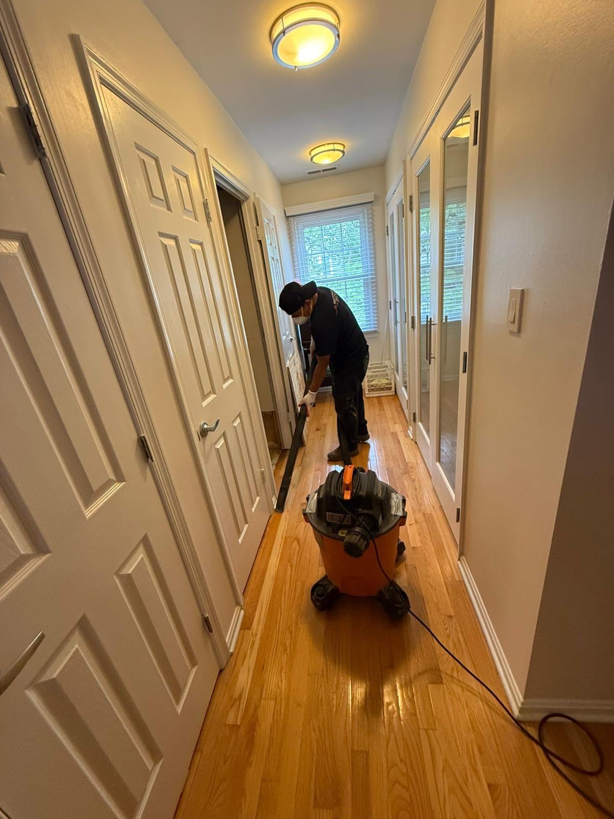 Standing water extraction underway in Arlington water damage restoration, initial assessment phase.