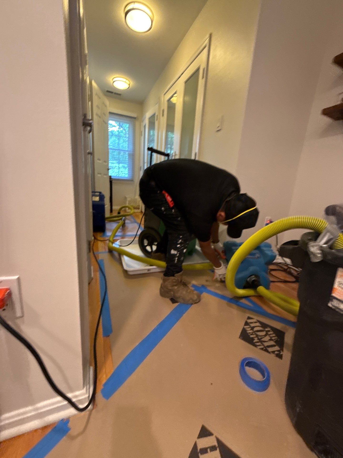 Wet structural materials exposed during water extraction and removal in Arlington restoration work.