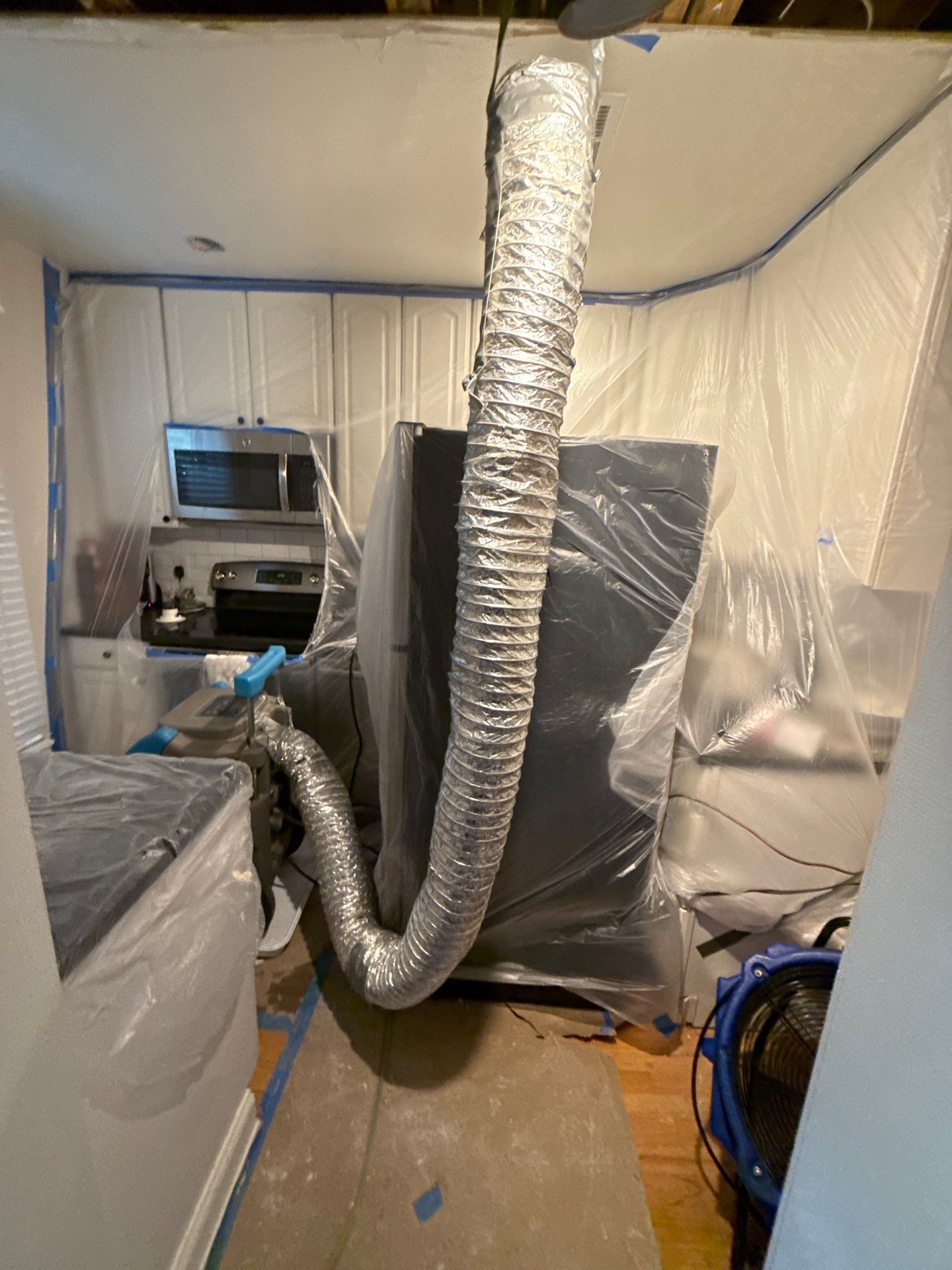 Drying equipment positioned to manage moisture in affected areas of Arlington home.