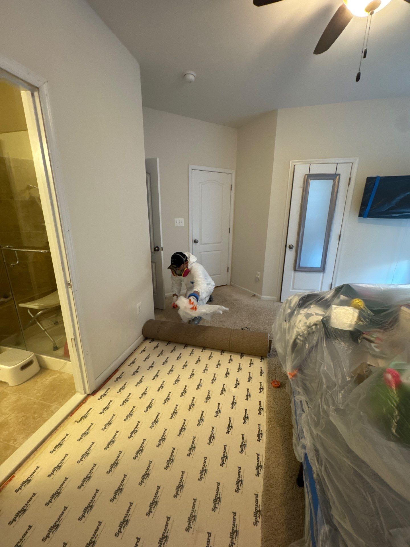 Wet carpet and padding removed, exposing subfloor for inspection and moisture assessment during remediation.