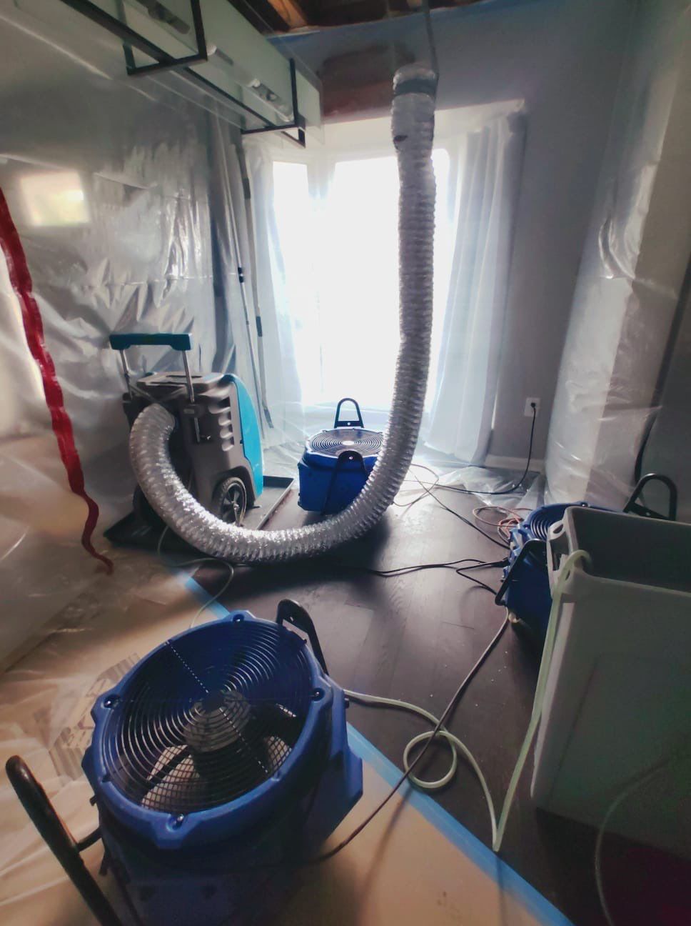 Containment barrier and extraction equipment set up during water damage restoration in Centreville.
