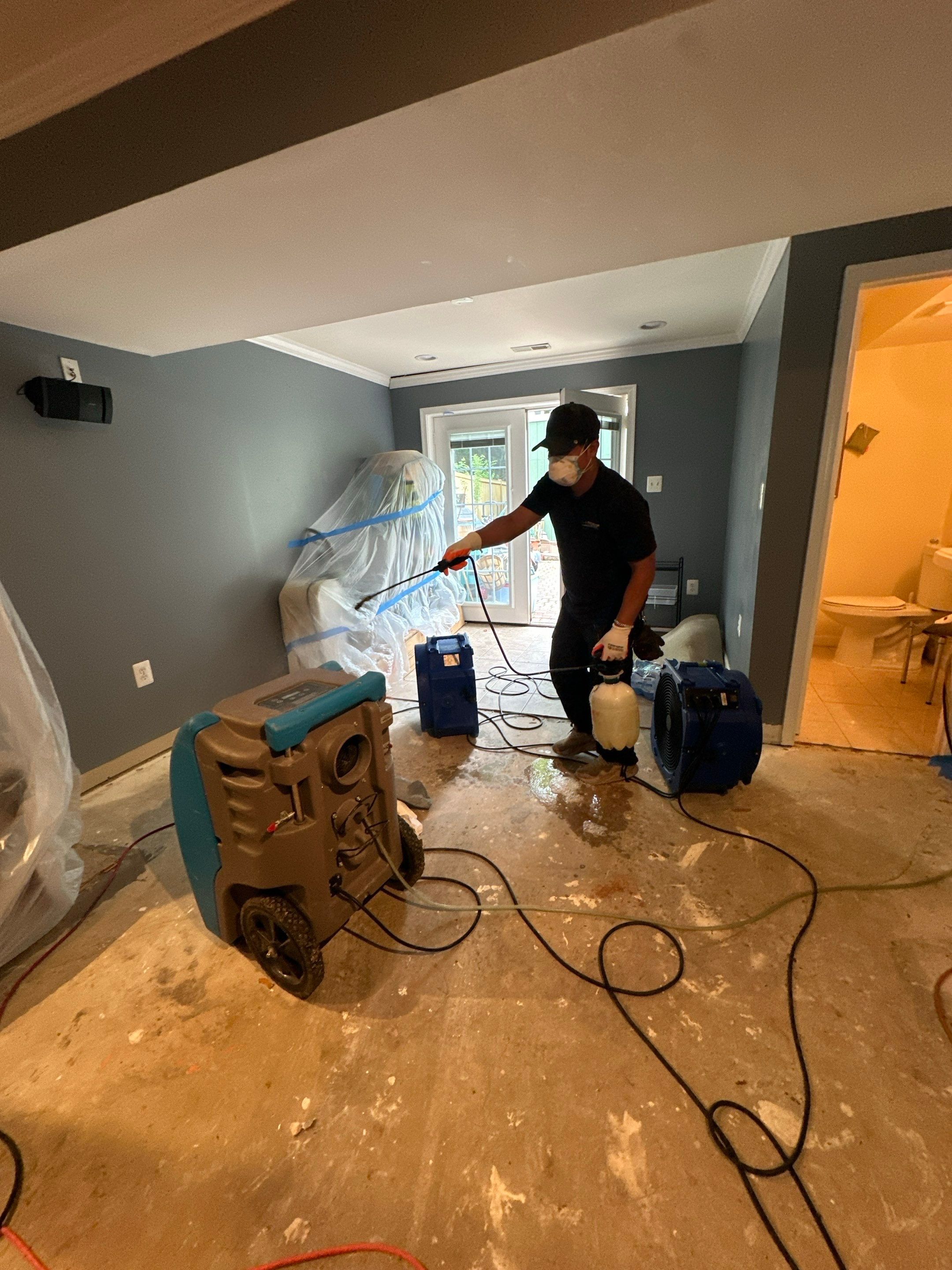 Final drying stage with equipment removal, showing restored room ready for flooring replacement.