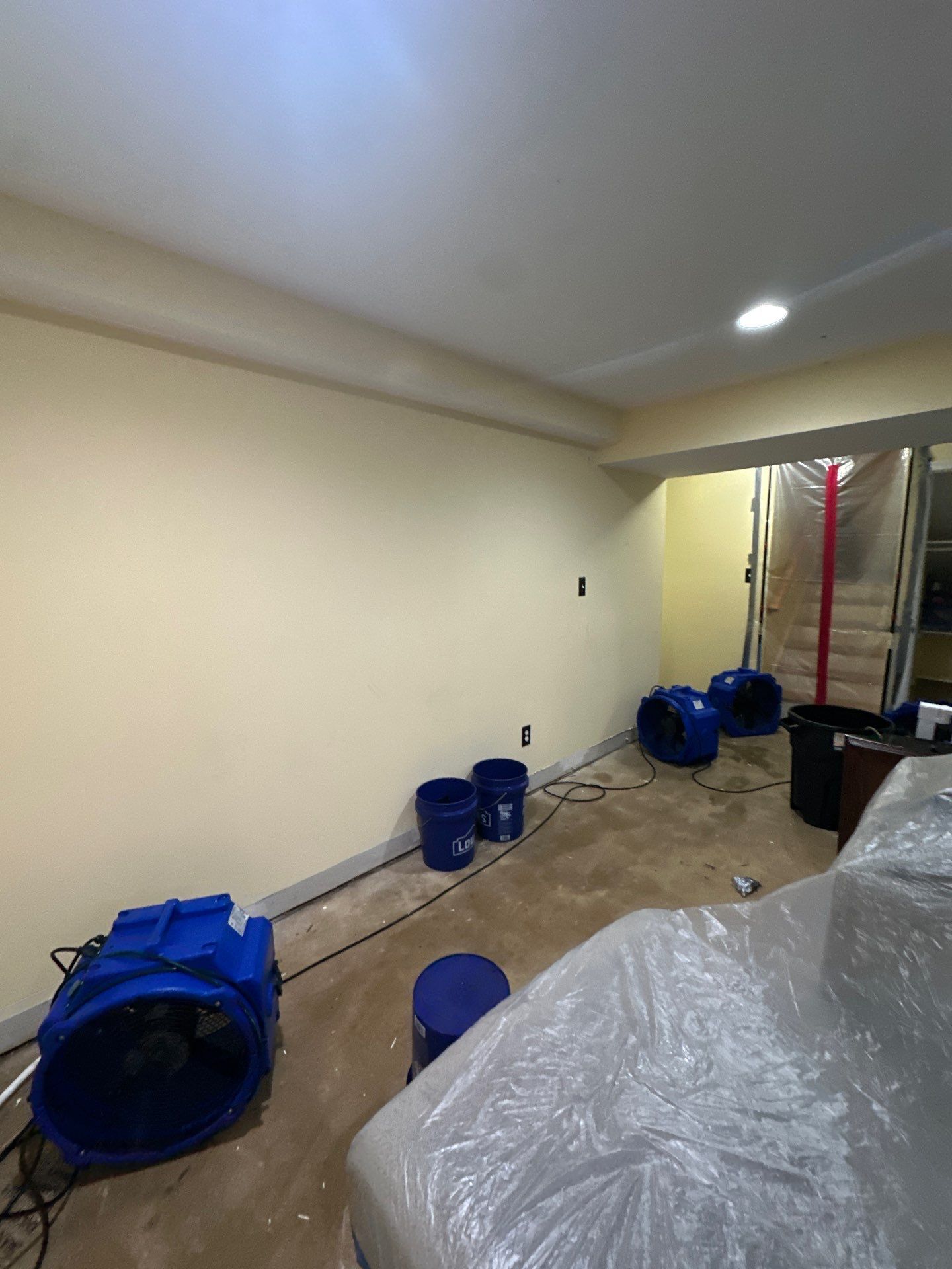 Continued dehumidification and air circulation supporting evaporation and moisture removal from building materials.