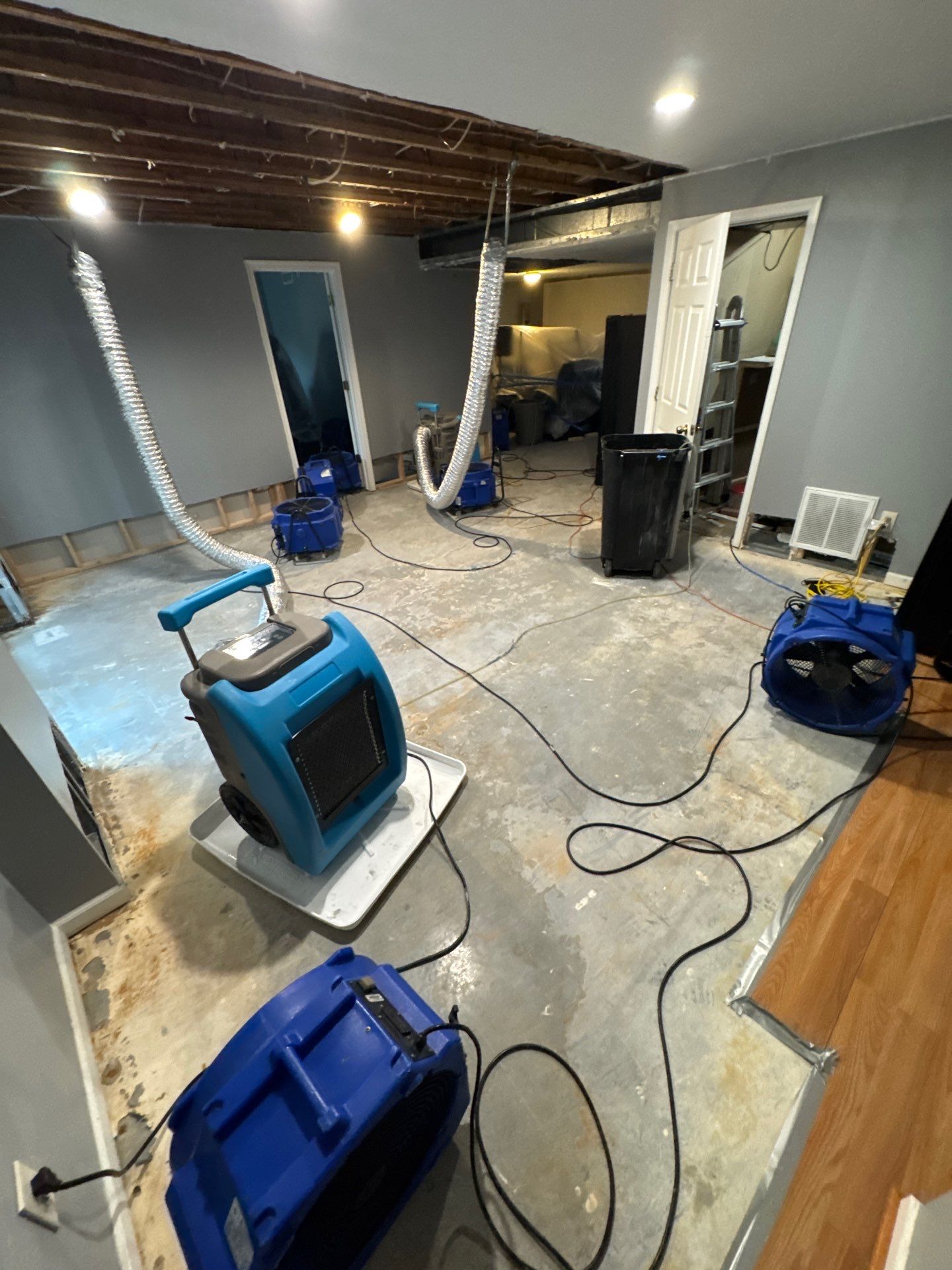 Mid-stage drying process showing containment enclosure and dehumidification equipment during ceiling repair work.