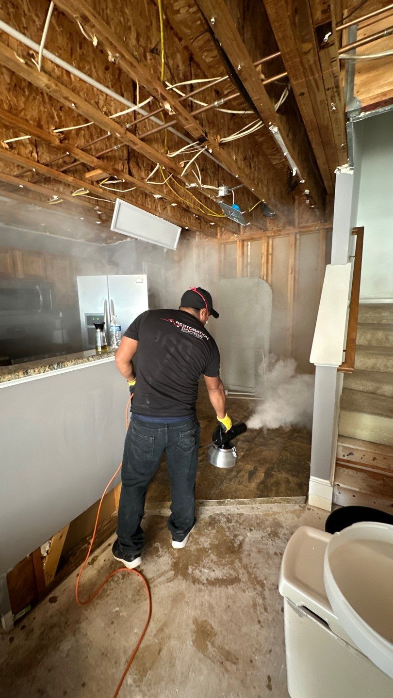 Mid-stage drying setup showing dehumidifier and air movers working to extract moisture from affected areas.