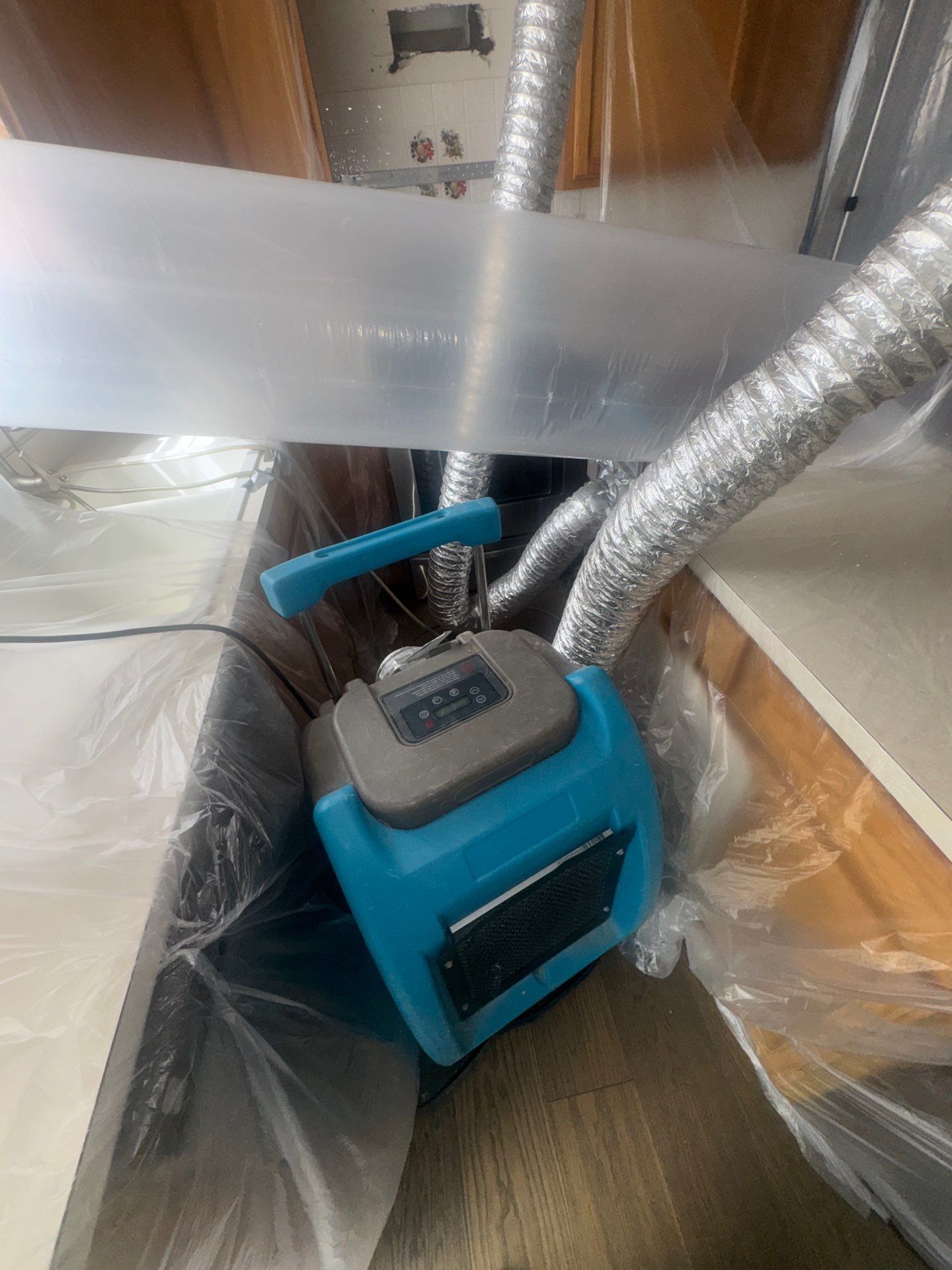 Drying equipment positioned to remove moisture from structural materials during mold remediation work.