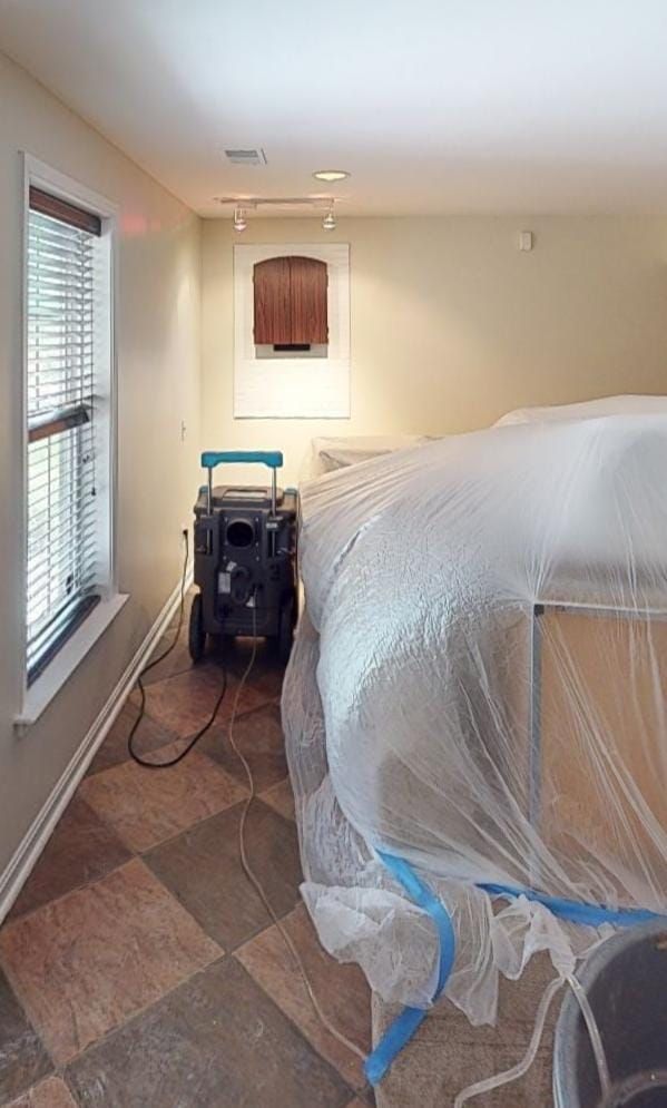 Water extraction and dehumidification equipment positioned in Lorton home during initial damage assessment.