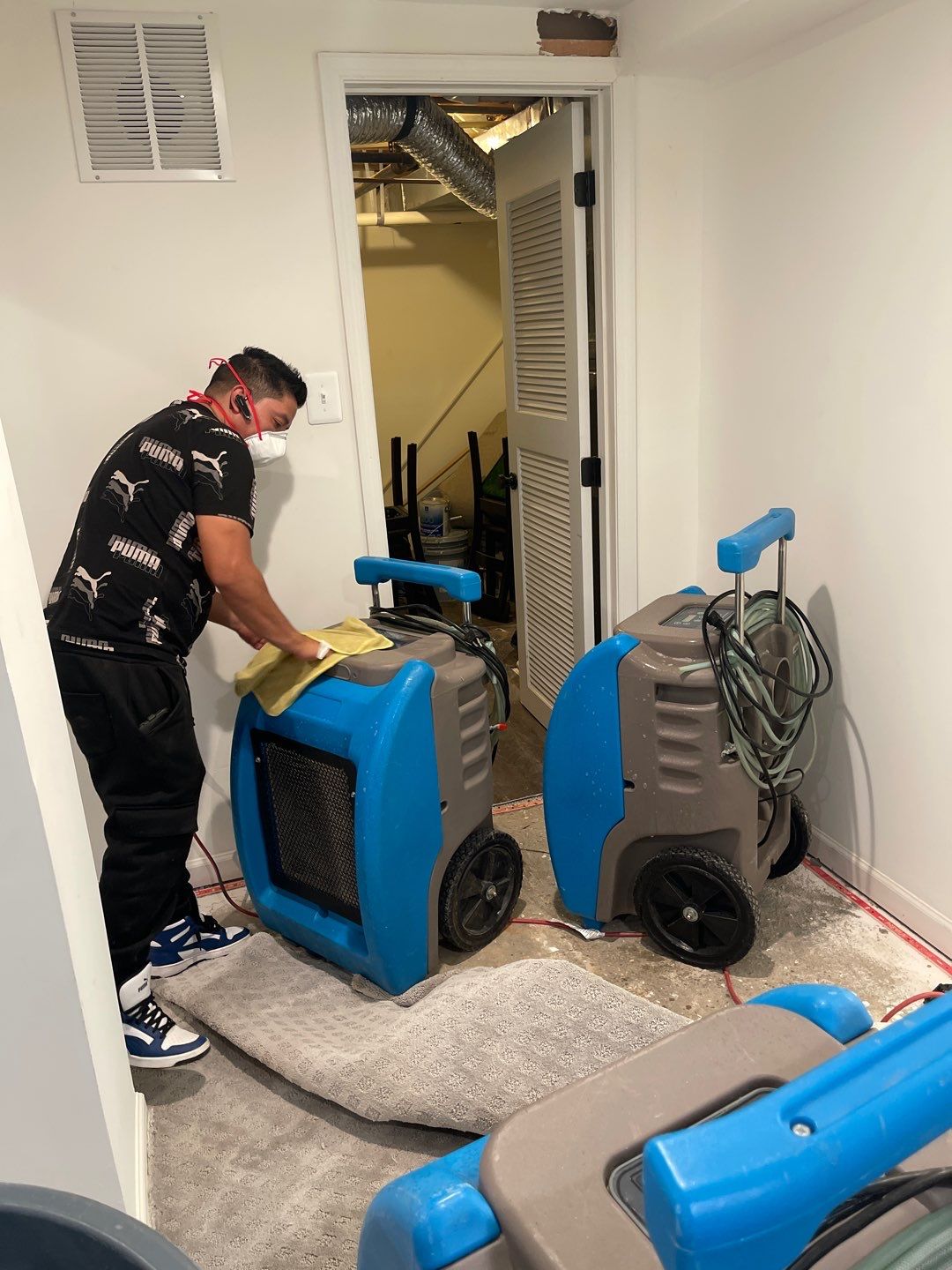 Dehumidification equipment positioned for structural drying during water damage mitigation.