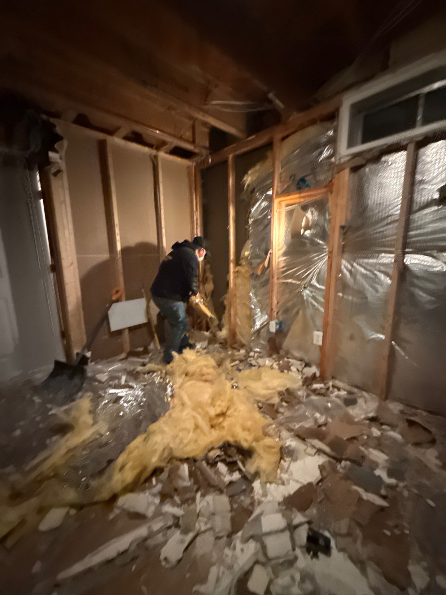 Standing water extraction underway in Manassas water damage restoration, industrial extractors removing pooled water from flooded interior.