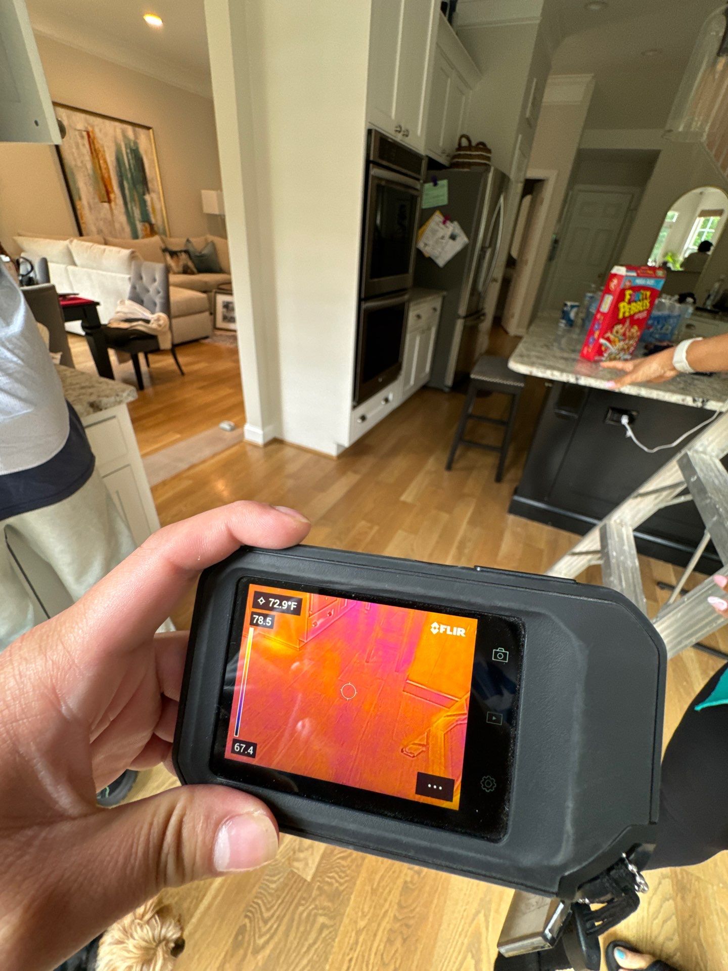 Thermal imaging camera capturing moisture patterns in drywall during water damage assessment in Bristow.