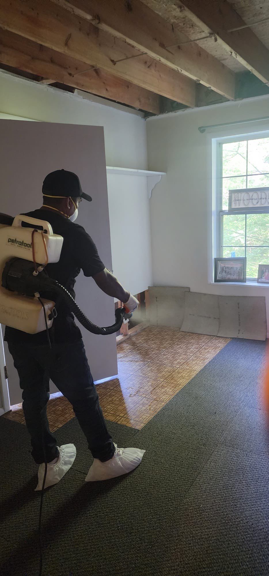 Water-damaged carpet and flooring in Montclair home with dehumidification equipment positioned for structural drying.