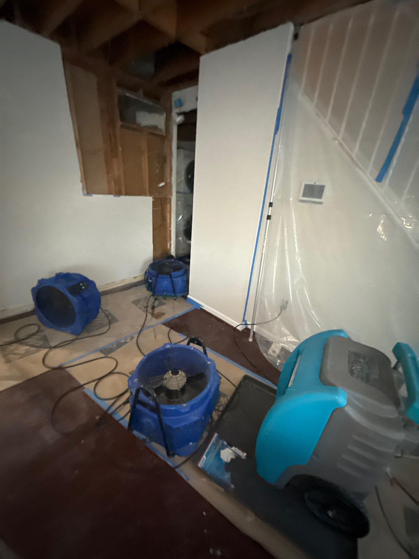 Drying equipment monitoring moisture levels in structural cavities during remediation.
