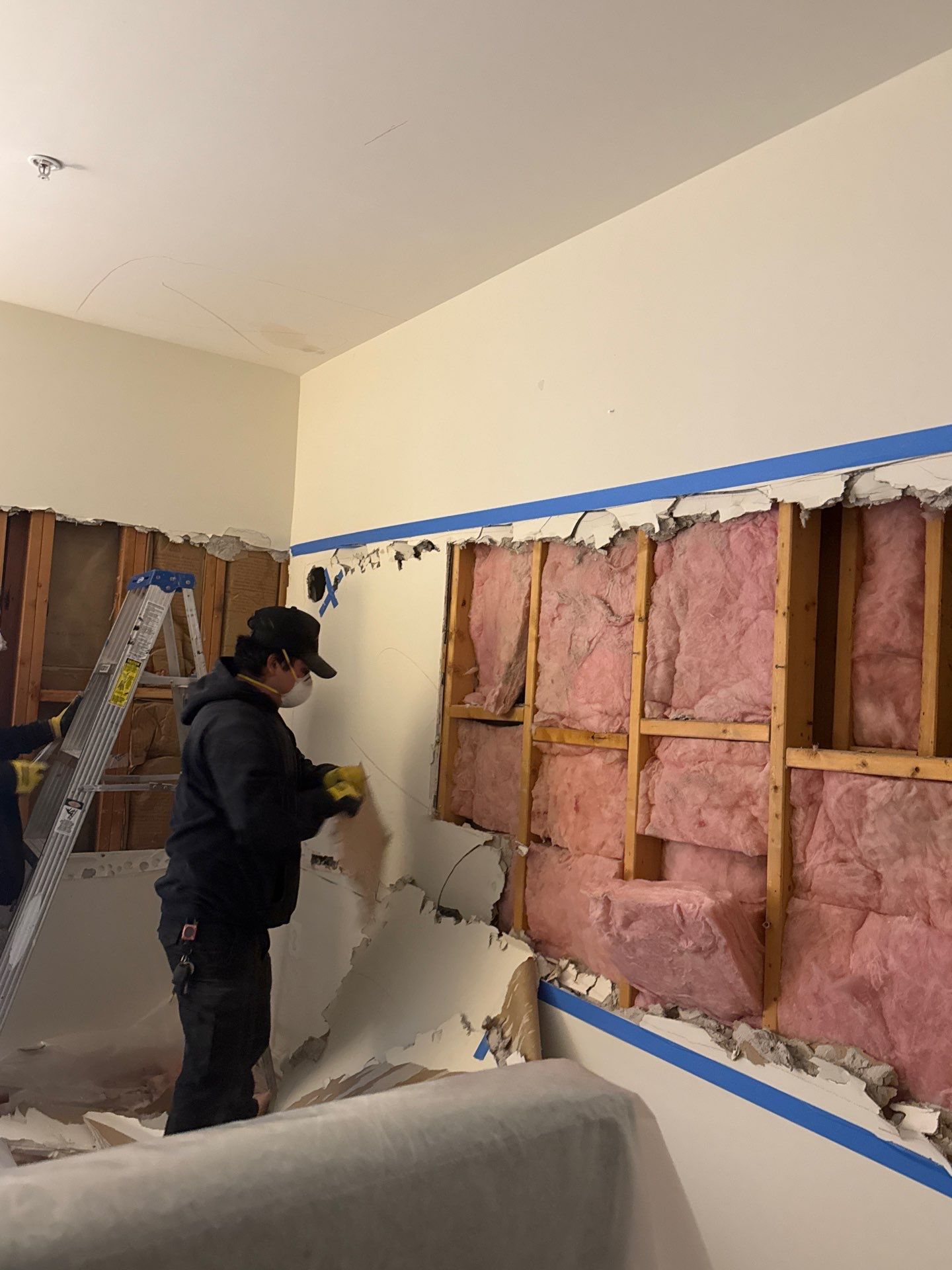 Removed wall sections staged during water damage restoration in Alexandria.