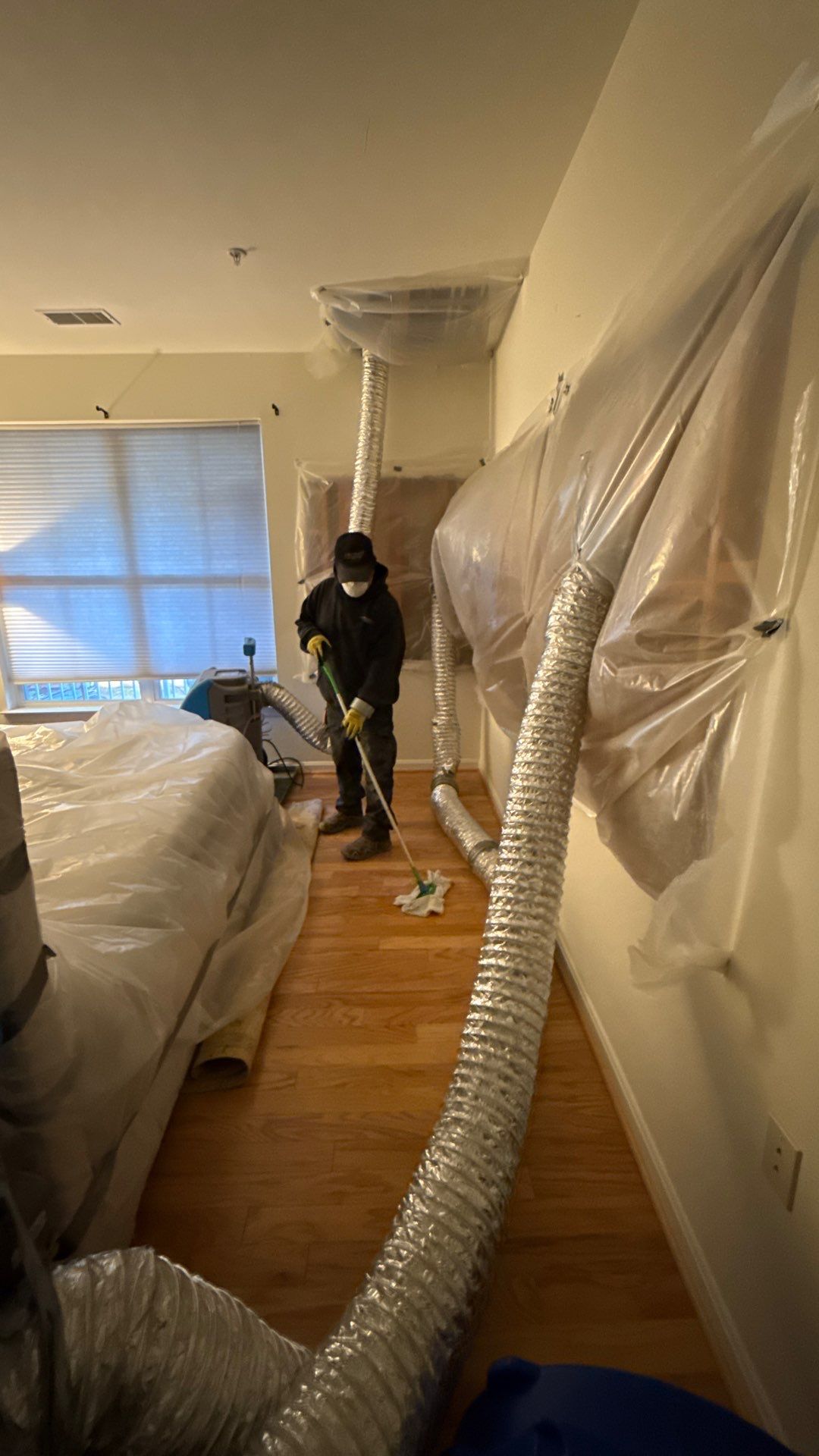 Wet drywall and framing being assessed for removal during Alexandria water restoration work.
