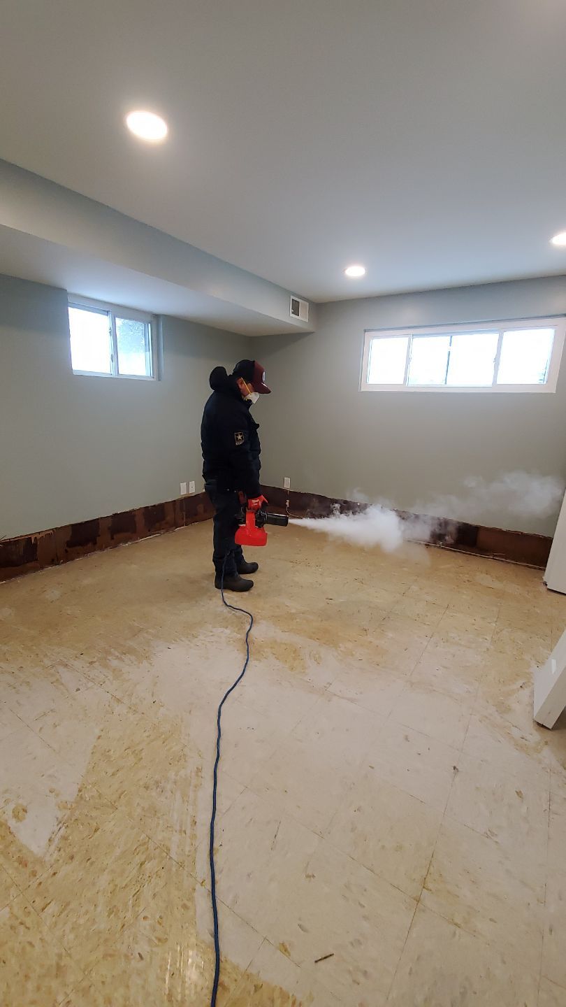 Standing water extraction underway in Springfield water damage restoration, wet flooring exposed.