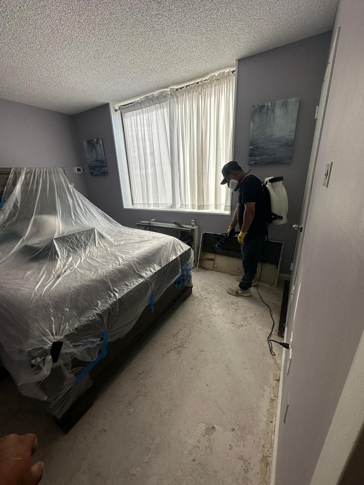 Standing water extraction underway in Baileys Crossroads water damage restoration, removing pooled water from affected interior space.