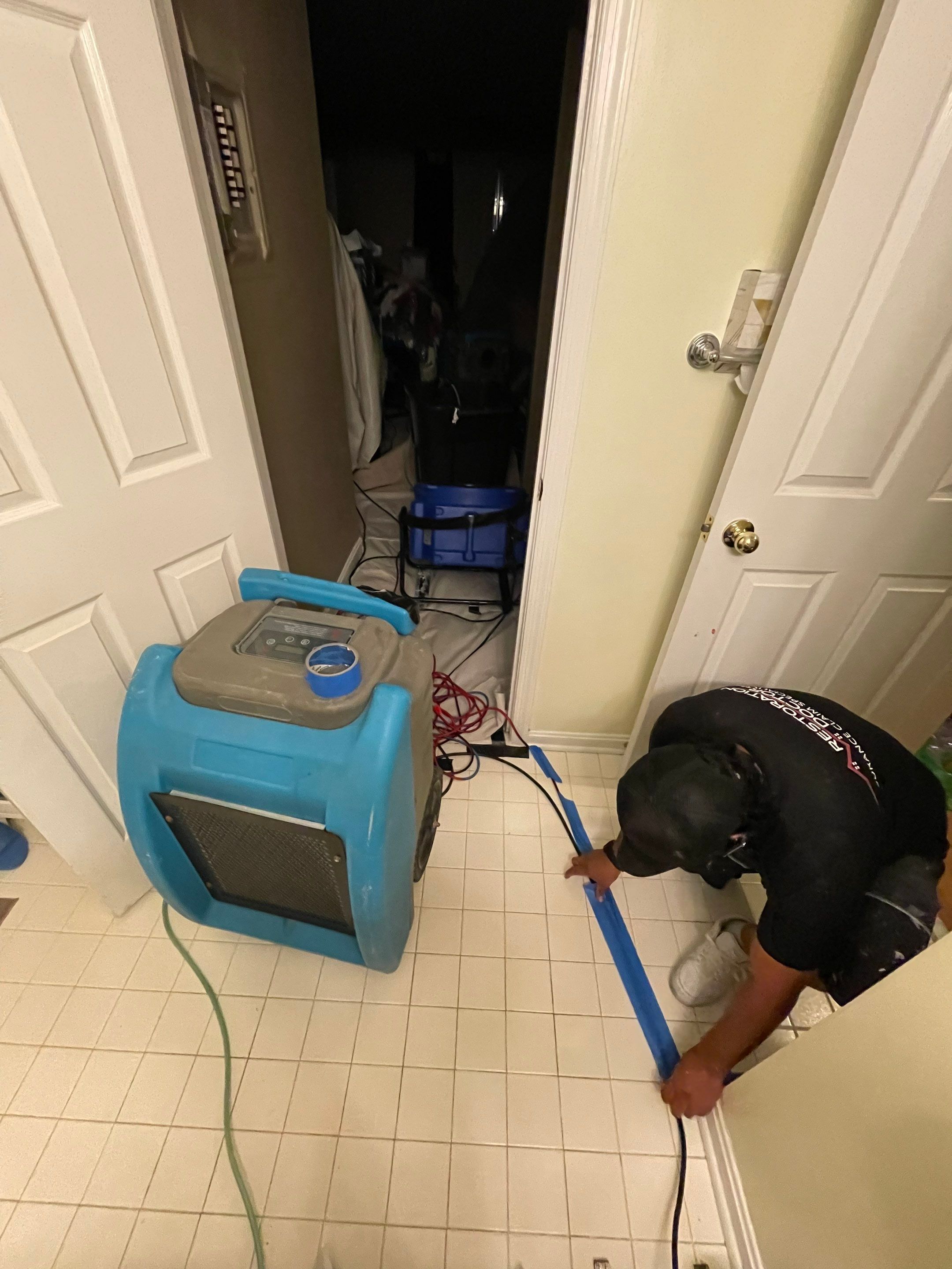 Final-stage water damage restoration in Alexandria with containment and drying equipment in place.