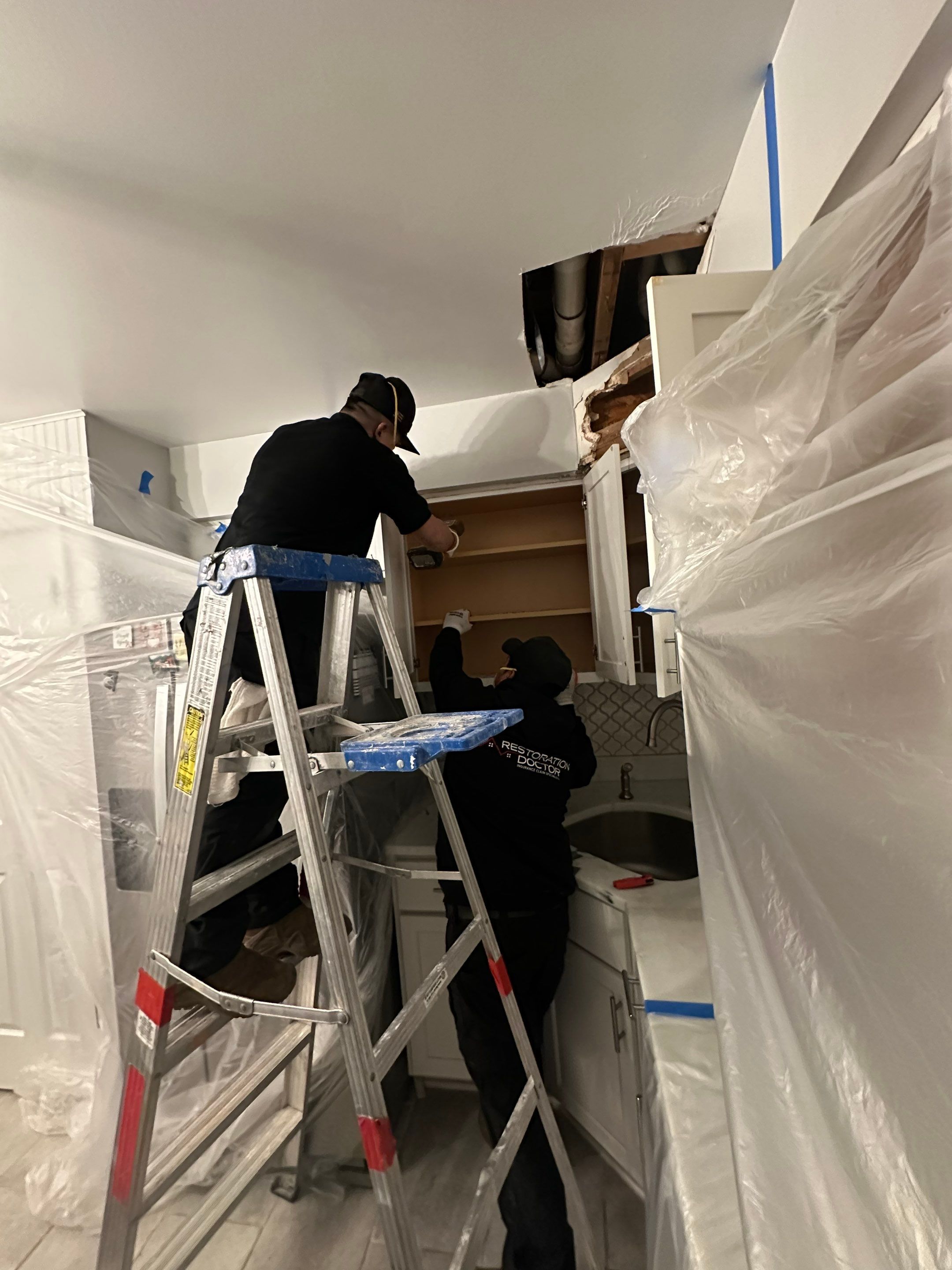 Dehumidification and air-handling equipment staged within containment to support structural drying.