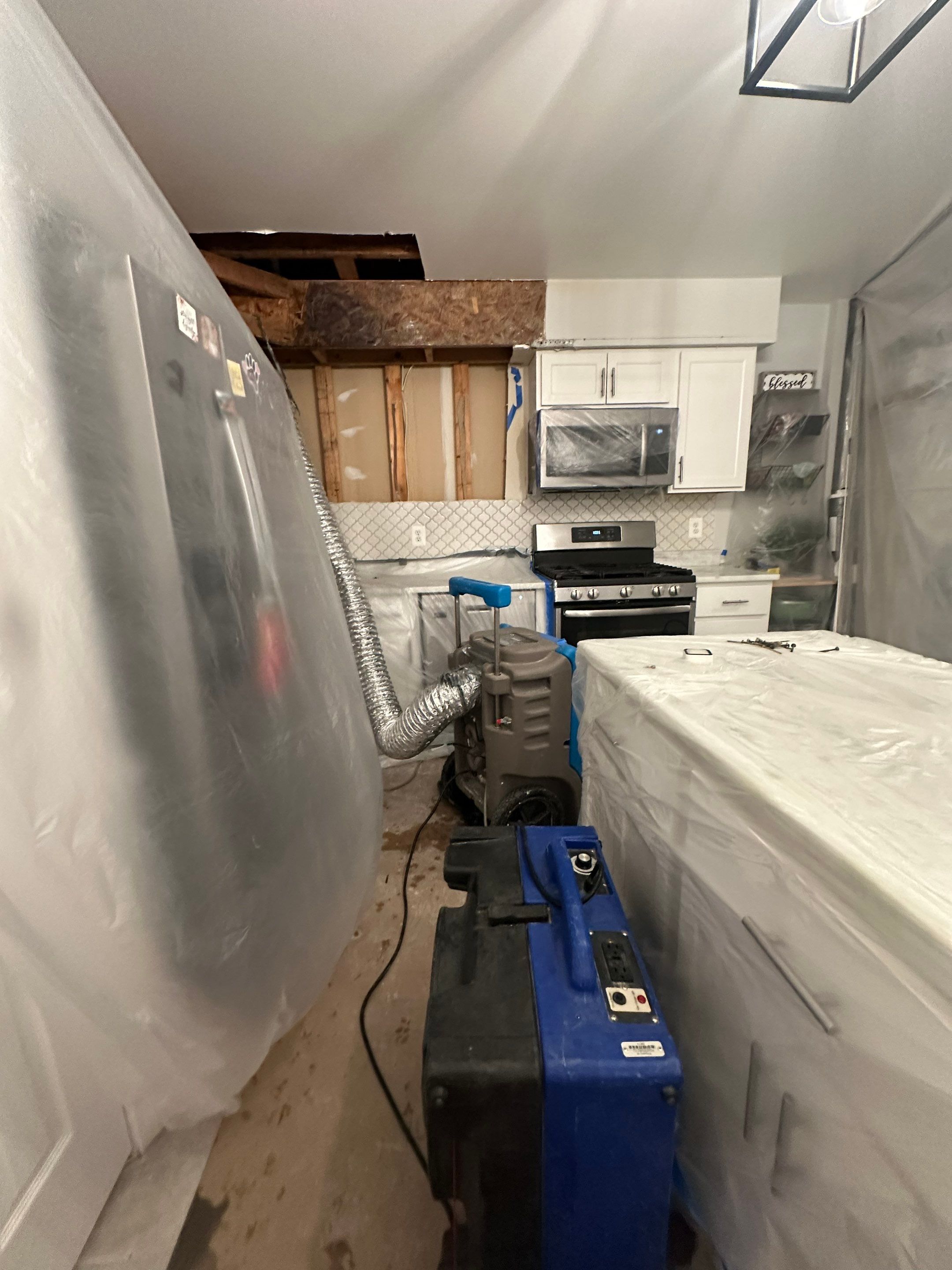 Containment barrier removed after structural drying complete, final inspection of remediated surfaces.