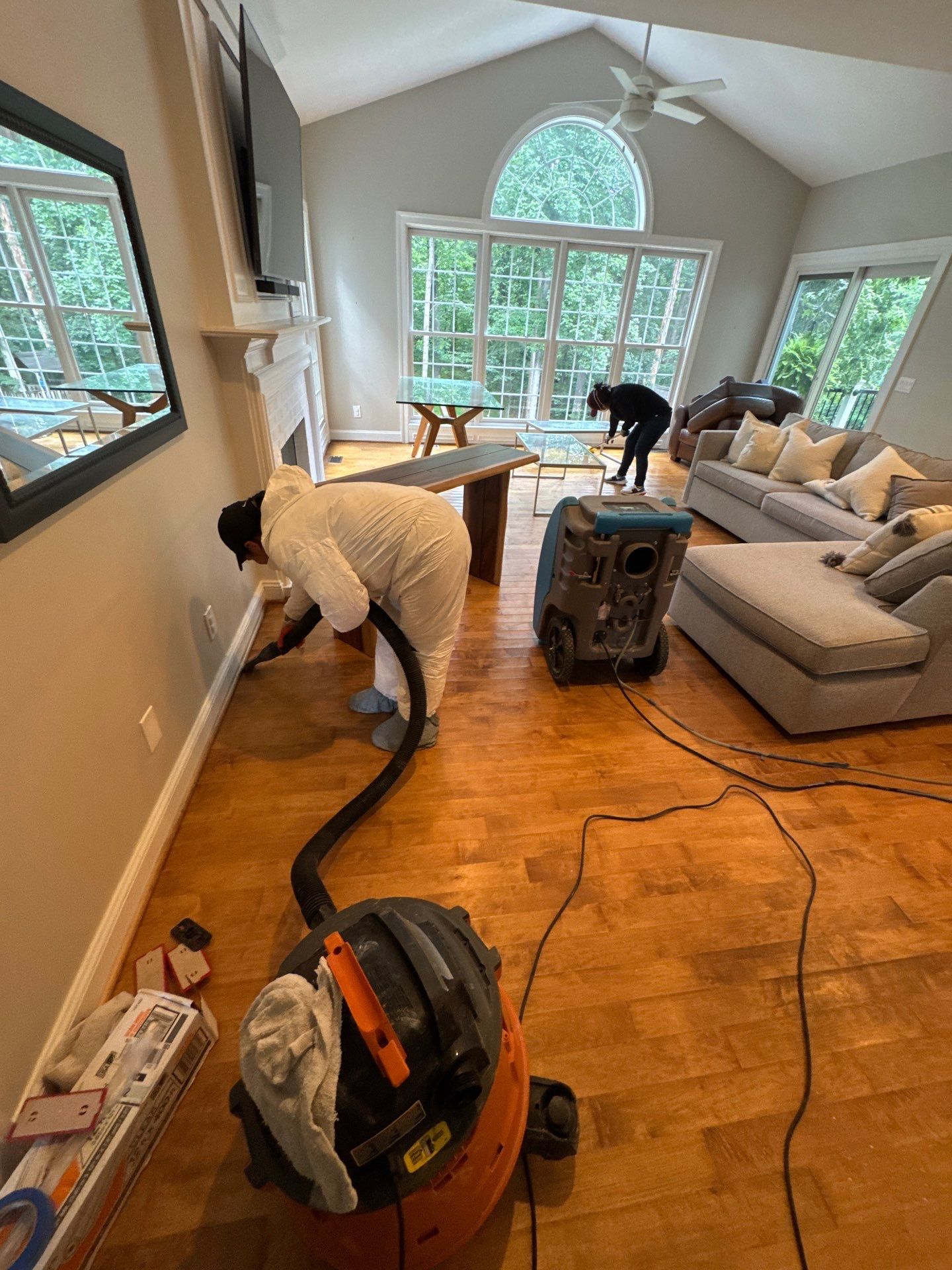 Standing water removal in progress during Oakton water damage restoration, extractors deployed across affected room.