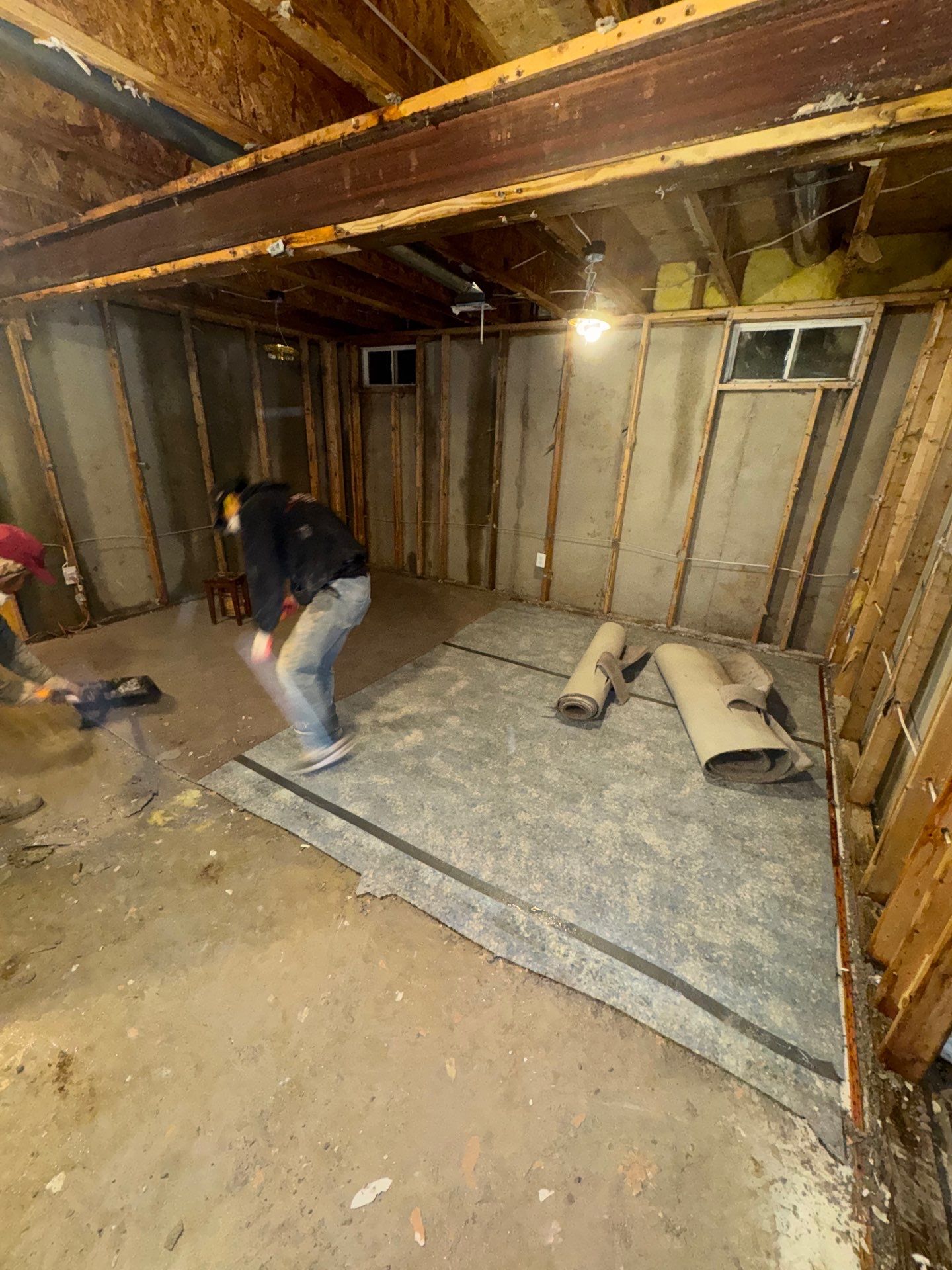 Water damage restoration in Manassas: drying equipment positioned in room with wet ceiling and flooring damage visible.